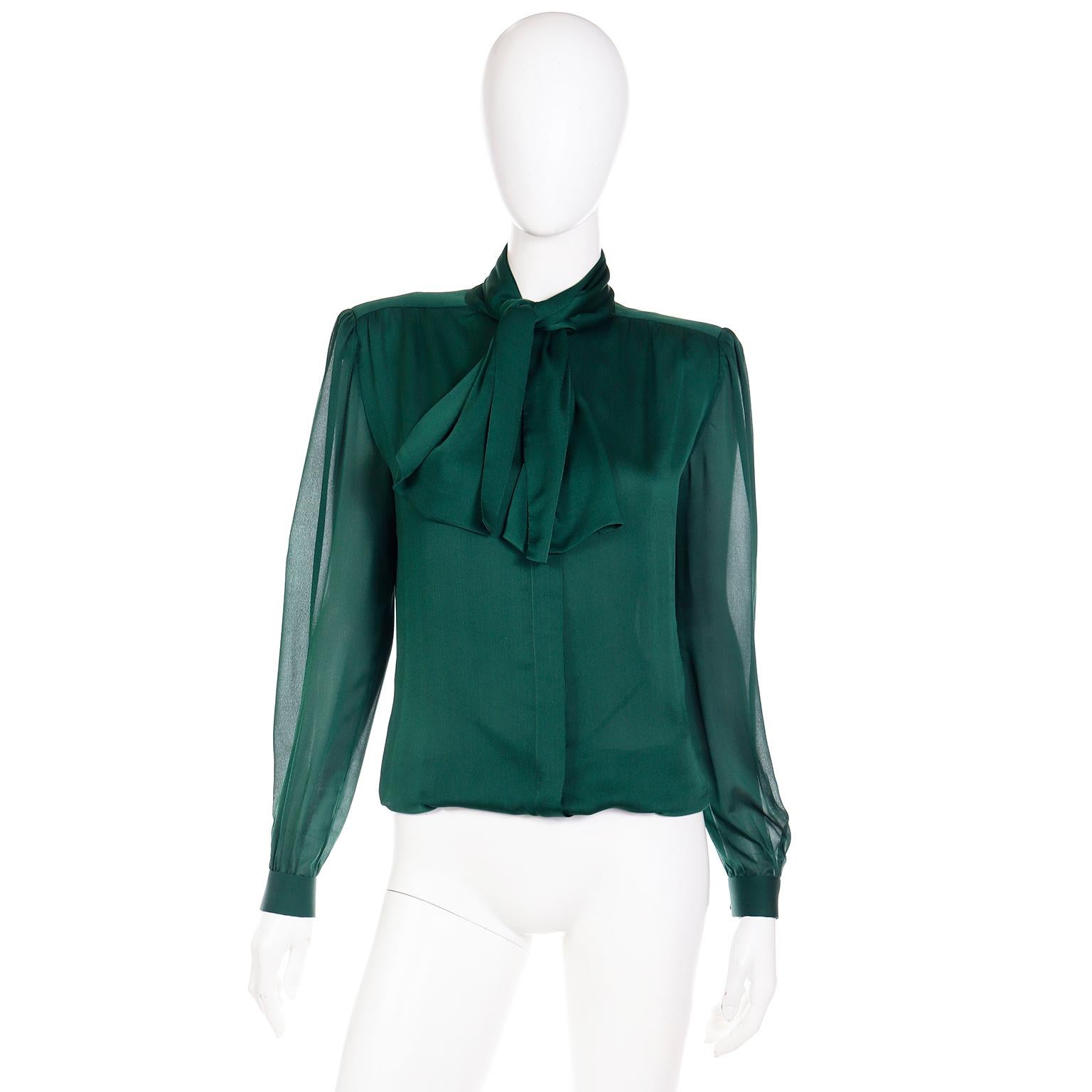 This is a luxe silk vintage Valentino Couture green silk blouse with an attached sash style neck tie that can be tied in a knot or bow. This beautiful blouse has sewn in shoulder pads for slight structure that could easily be removed. The sleeve