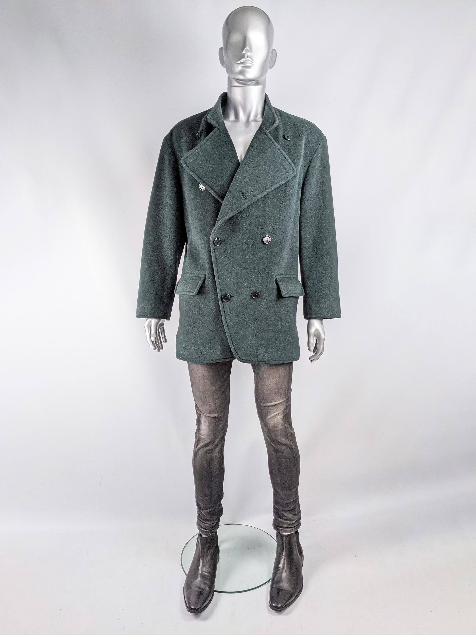 An amazing and rare vintage mens Valentino Couture mens jacket from the 80s. Made in Italy In a luxurious forest / bluish green wool fabric with a strtiped cotton lining, double breasted buttons creating a peacoat inspired look and an unusual stand