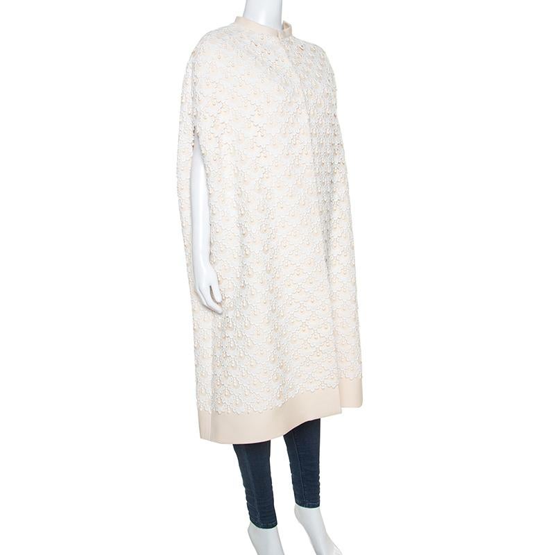 This stunning creation from the house of Valentino has been created exquisitely. The cape is made from a blend of quality materials and features Guipure lace all-over. The subtle combination of cream and white is very stylish and has an air of