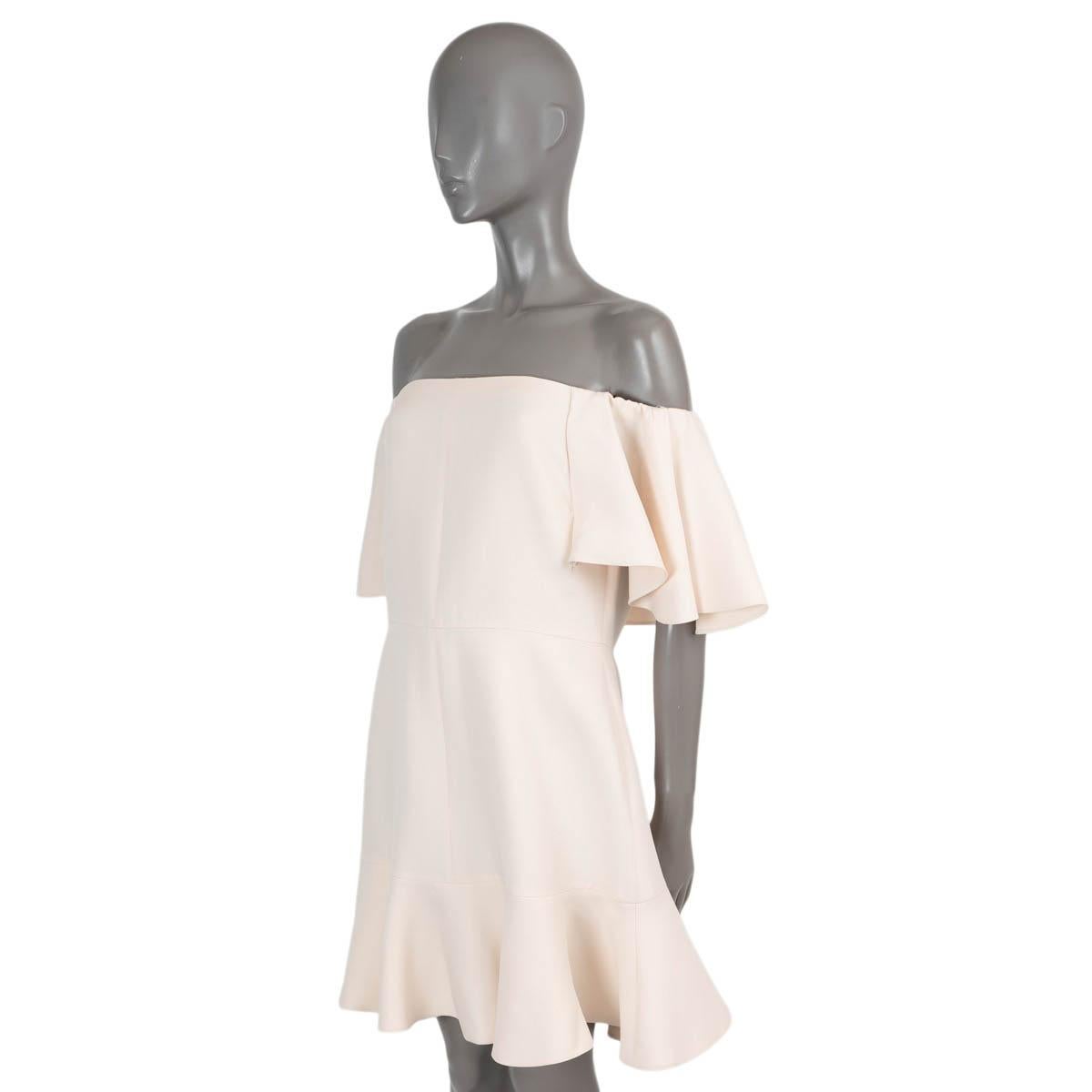 100% authentic Valentino off-shoulder dress in cream crêpe wool (65%) and silk (35%). Features ruffled short sleeves and fluted skirt. Opens with a concealed zipper in the back and is lined in silk (100%). Has been worn and is in excellent