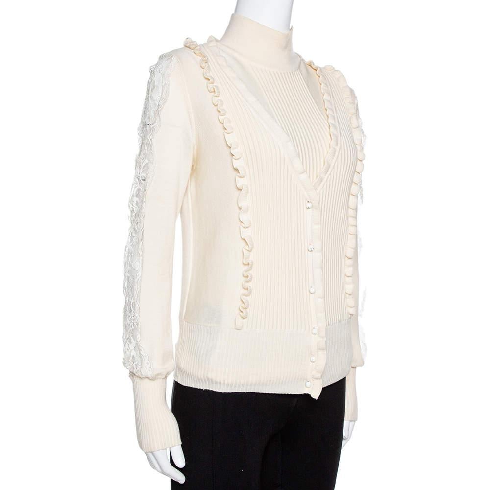 Who doesn't love creations that are both comfortable and stylish at the same time! This cream set from Valentino comes with a cardigan and matching sweater. The turtle neck, sleeveless sweater as well as the long-sleeved cardigan features soft