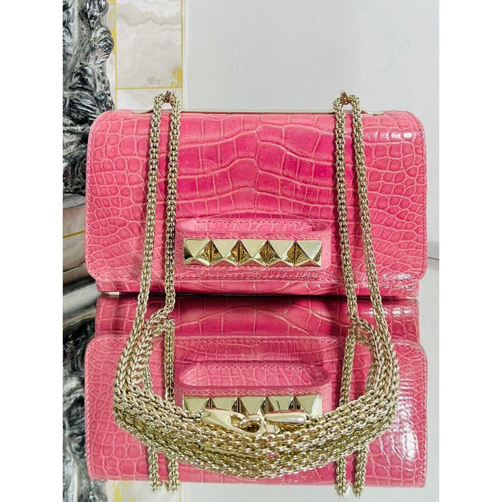 Valentino Crocodile Skin Va-Va-Voom Handbag

Dusky pink exotic skin handbag, with champagne gold hardware. Signature pyramid stud trim with hand held section to the front and chain attached via the metal trim to the top of the bag

Additional
