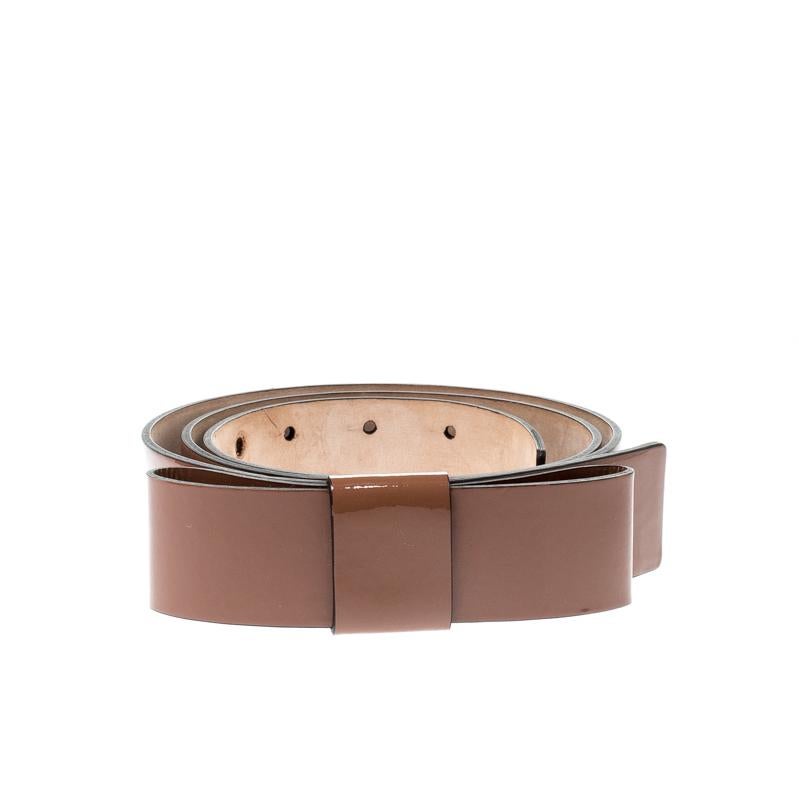 From Valentino's range of accessories comes this belt made from patent leather. It is durable and minimal in design. The belt has a dark beige shade, a bow detail and overall, it gives off a luxe feel.

Includes: Original Box, Original Dustbag

