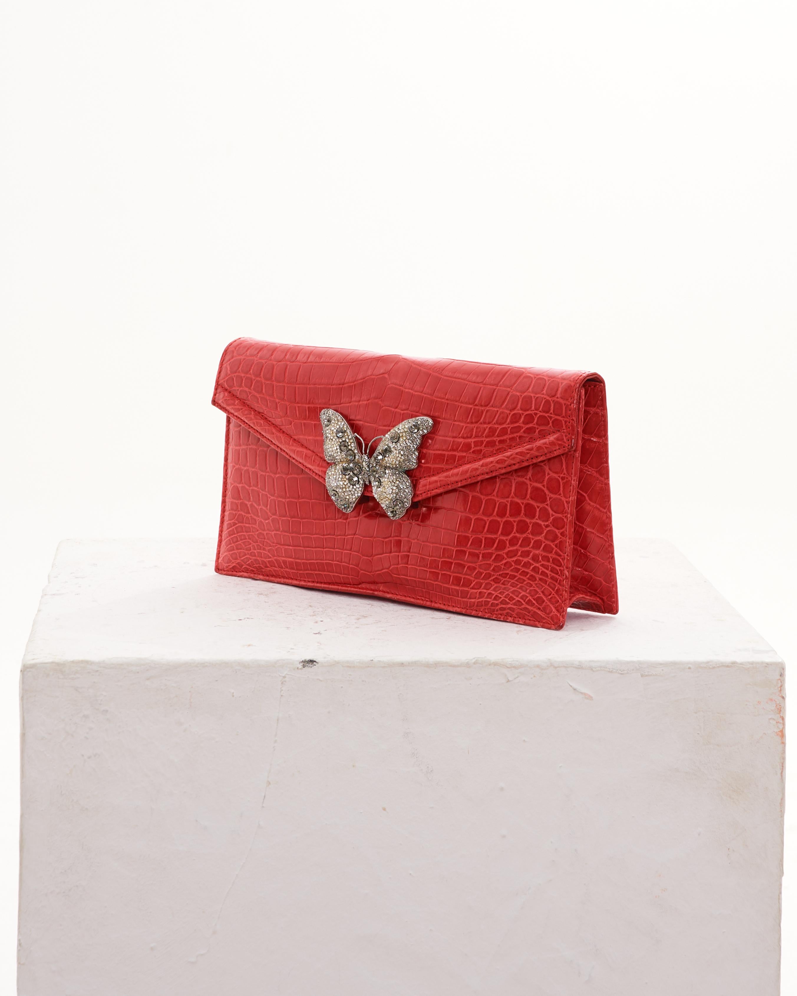 - Designed by Valentino Garavani
- Sold by Skof.Archive
- Early 00's
- Red Embellished Croco Bag
- Silver Butterfly Embellishment
- Crocodile Leather
- Inside Pocket in Leather
- Made in Italy
- Excellent Condition