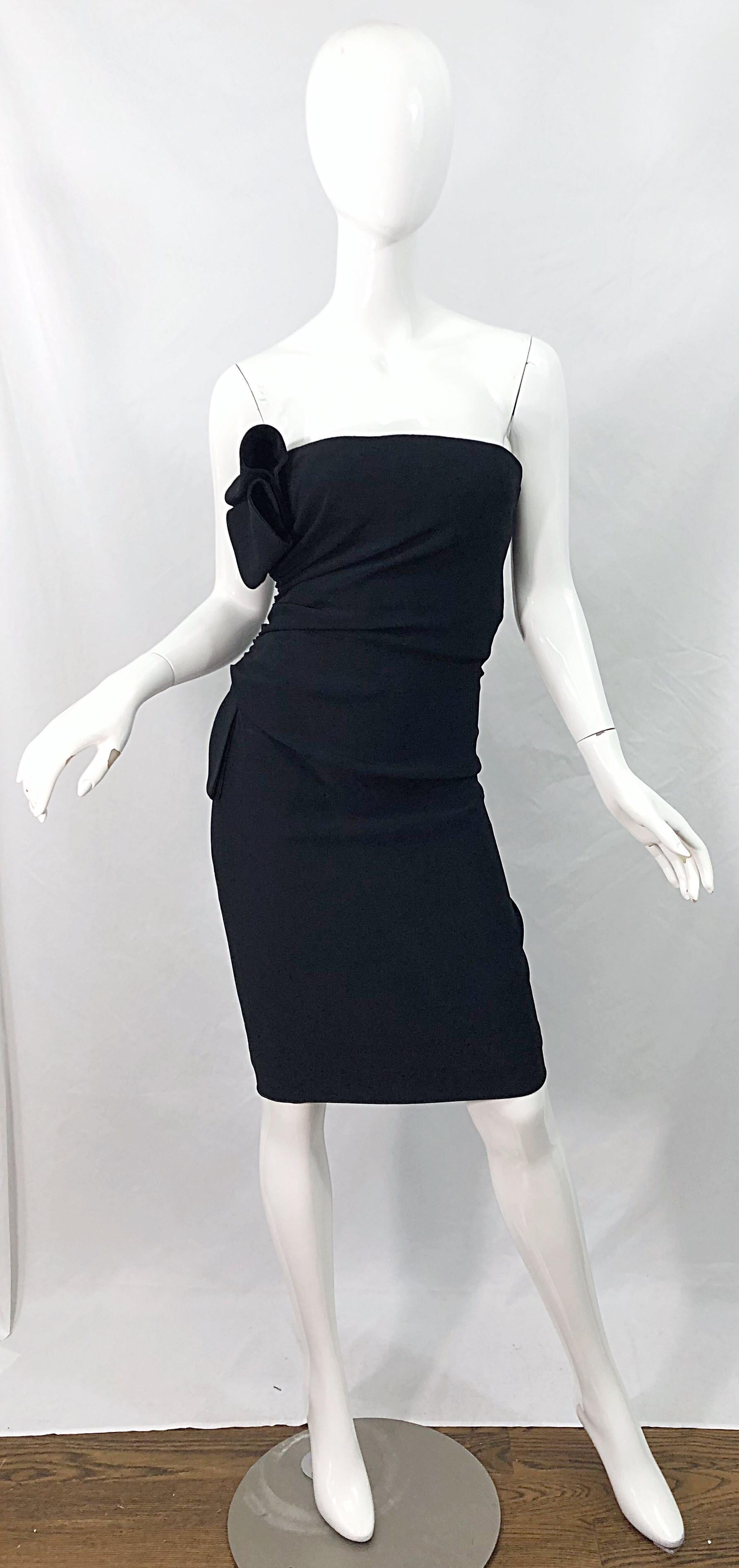 The perfect little Y2K black dress from the house of VALENTINO ! Features a tailored fit with some give. Avant Garde details with accent details at left bust and waist. Interior support holds everything in place. Hidden zipper up the side with