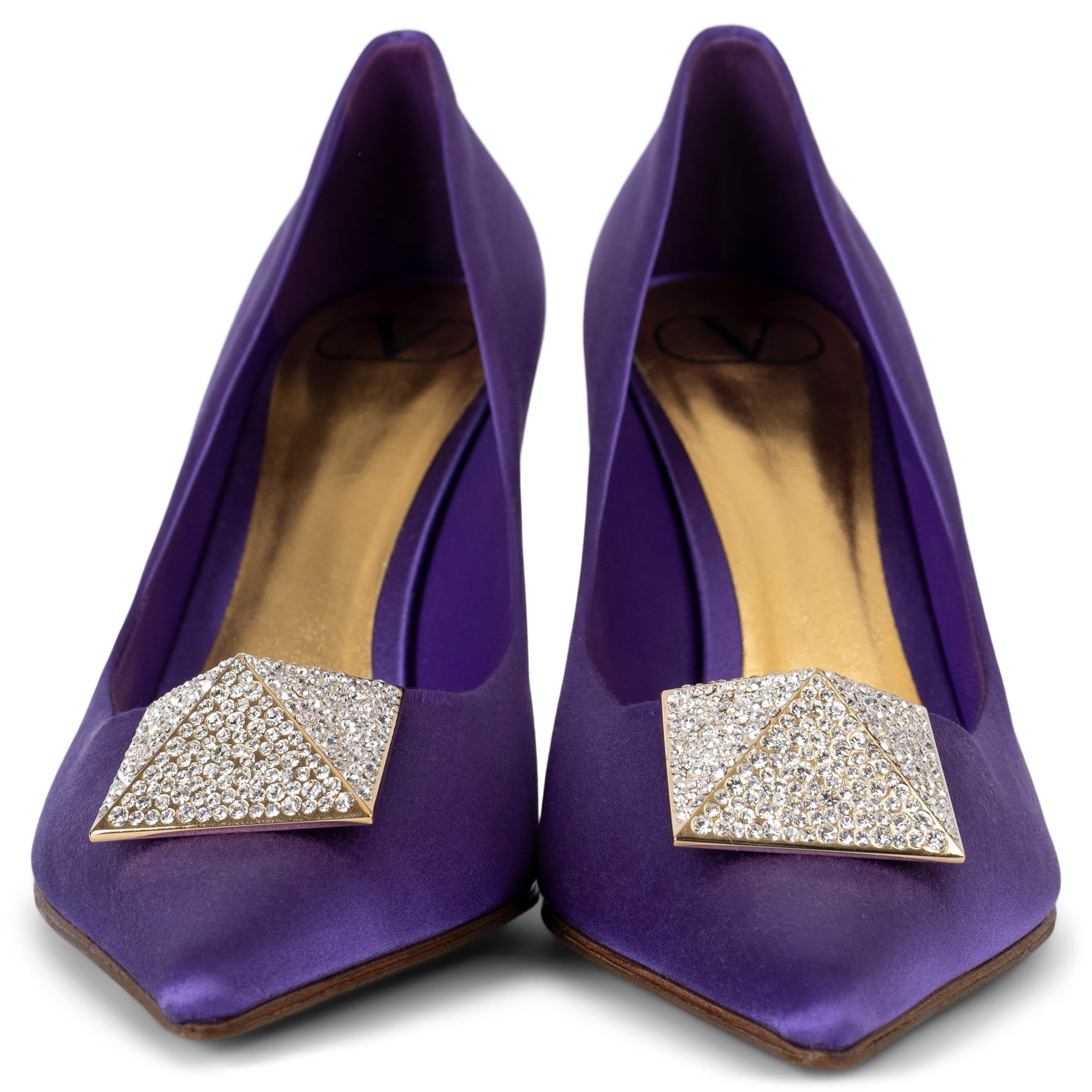 These 100% authentic Valentino One Stud pumps in Electric Violet satin are a bold and glamorous statement piece. They feature a crystal-adorned Rockstud pyramid embellishment, pointed toes, and a sleek stiletto heel. Perfect for adding a touch of