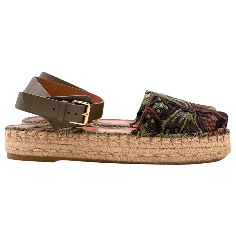  Valentino Embroidered Espadrilles

-Espadrilles with green wrap around ankle straps
-Embroidered butterfly and floral detailing 
-Grosgrain platform
-Silver tone buckle
-Peeptoe

Please note, these items are pre-owned and may show signs of being
