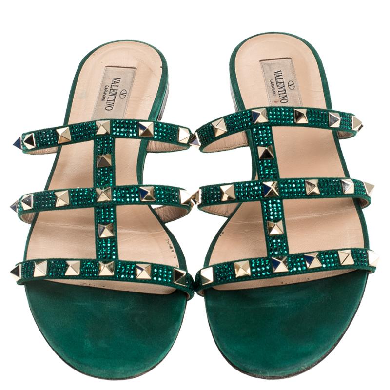 These Valentino slides feature a gorgeous design of suede straps detailed with the signature Rockstuds and crystals. Easy to slide it on and off, these pair makes a great accompaniment to dresses and skirts alike.

