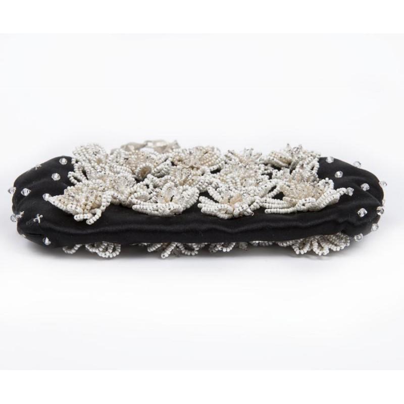 Very cute valentino small evening bag !

Material : silk satin 
Color : black 
There are pearl flowers sewn and set with brilliants on the 2 sides of the bag. A few diamonds are missing (not very visible). 
The lining is nude satin. The jewelry is