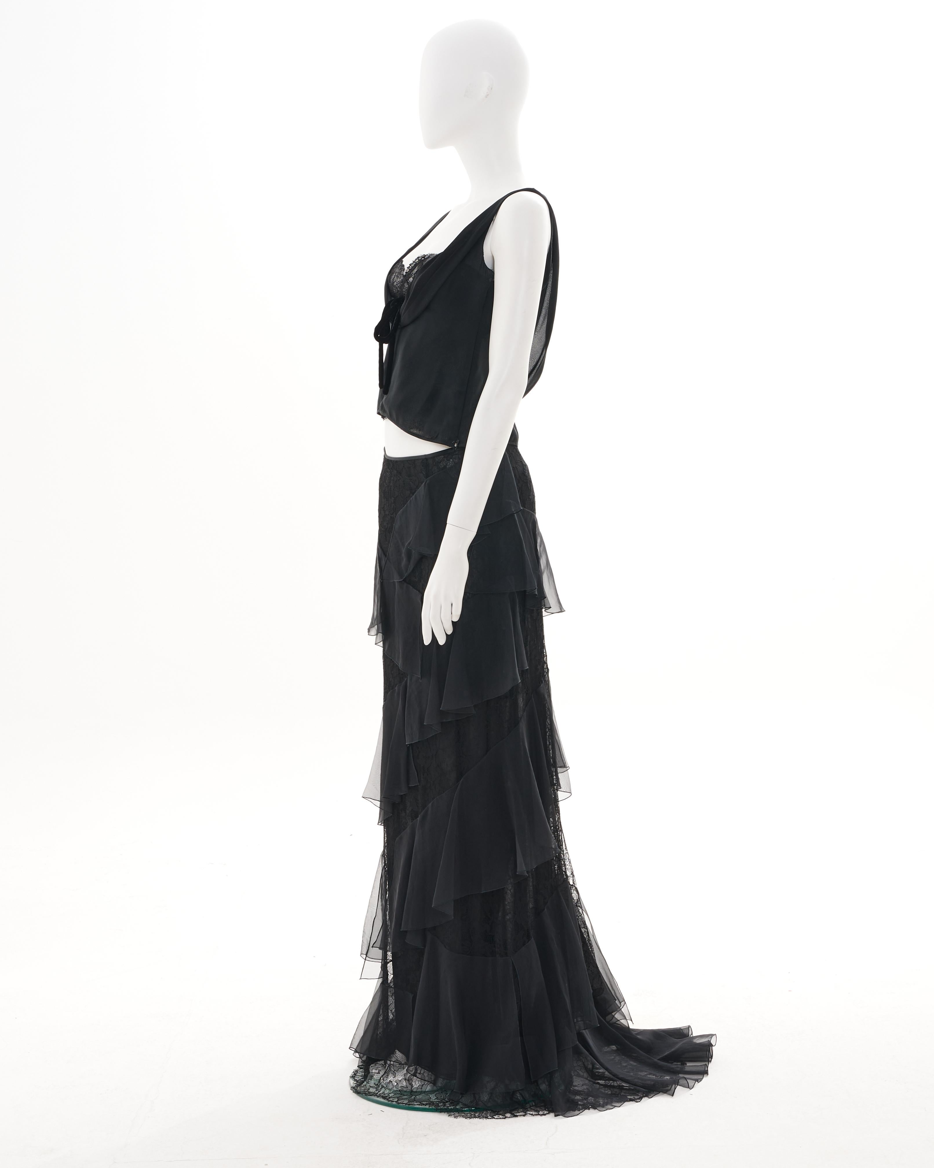- Designed by Valentino Garavani 
- Sold by Skof.Archive
- Fall-Winter 2004
- Black silk and lace ruffled evening long skirt with train 
- Back hidden zipper closure 
- Black silk and lace crop top with hidden side zipper closure 
- Open back 
-