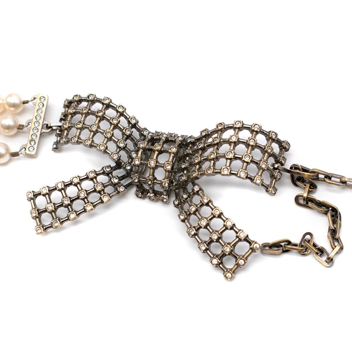 Valentino Faux Pearl Mesh Bow Buckle Belt

- faux pearl belt 
- three levels 
- metal bow detail to the front embellished with crystals
- hook adjustable fastening to the bow part

This item comes with the original dust bag.

Please note, these
