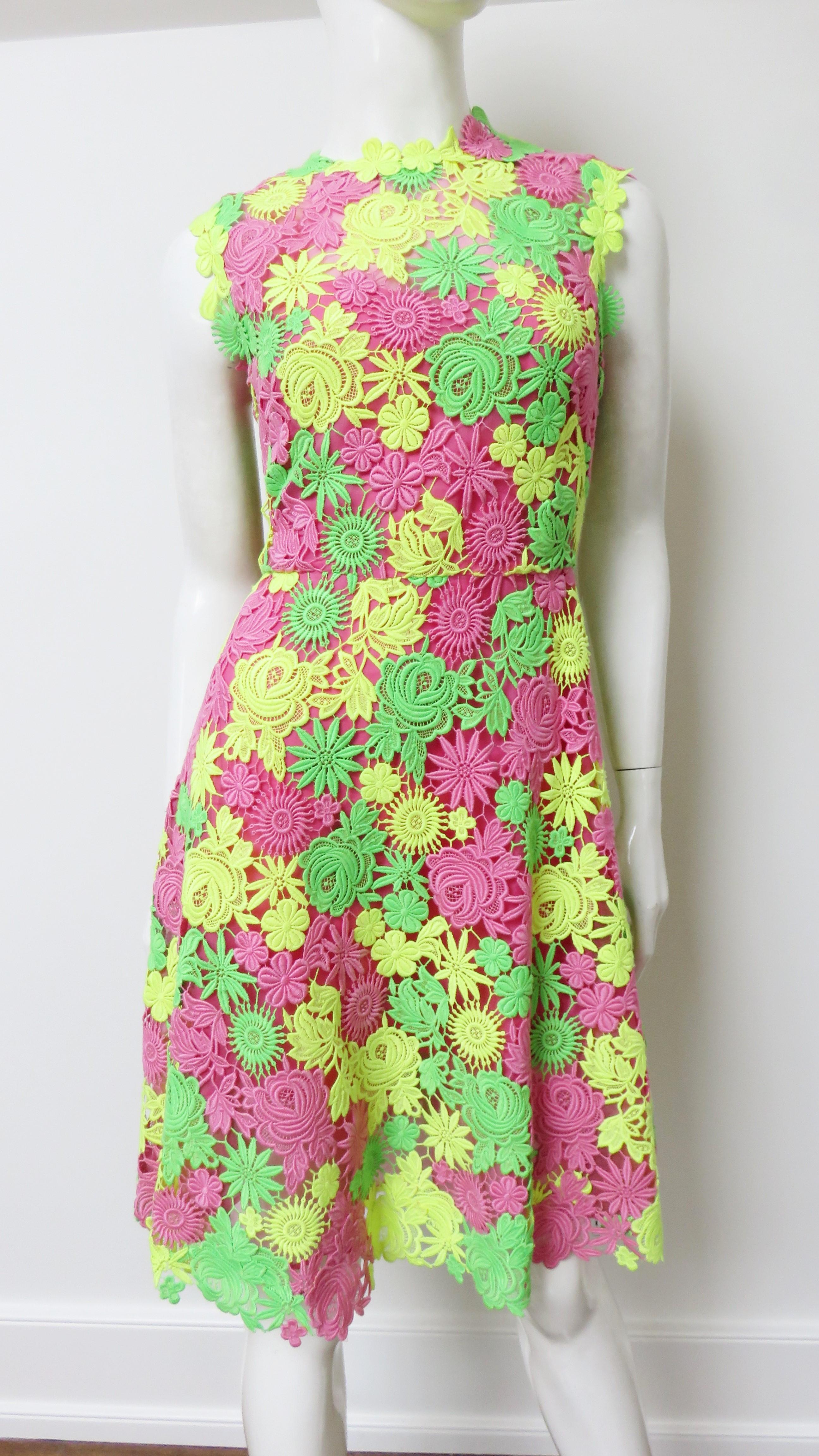 A gorgeous green, yellow and pink flower pattern lace dress from Valentino.  It is sleeveless with a crew neckline, fitted waist and full skirt. The dress is lined in pink silk and has a back zipper.
Fits size Medium. Marked Italian size 44.

Bust 