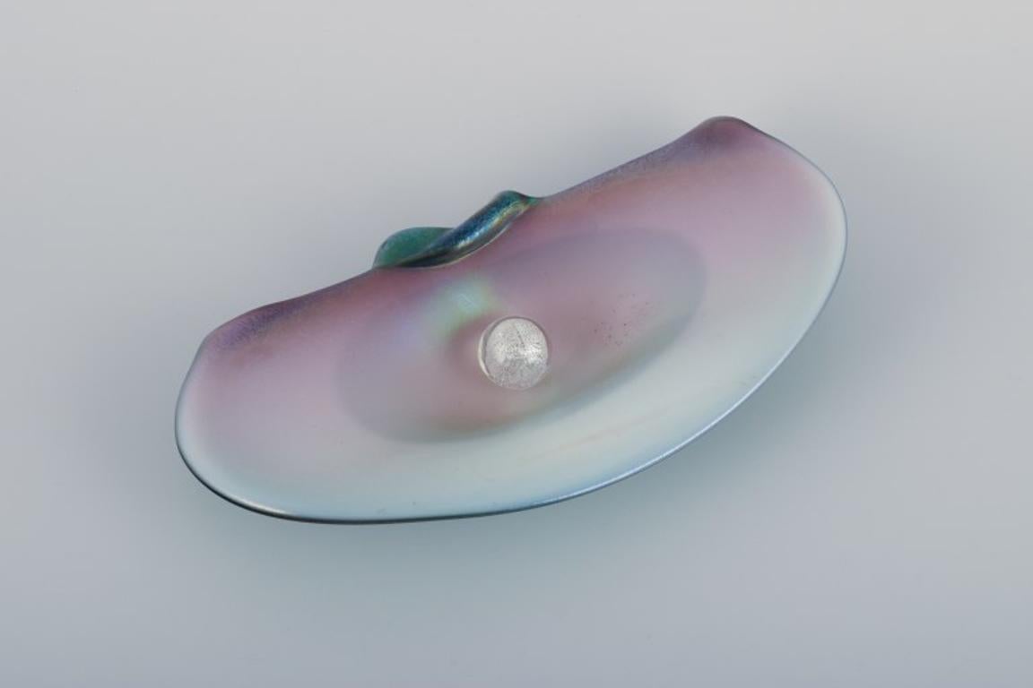 Valentino for Murano, Italy. 
A rare art glass bowl shaped like a seashell with a loose pearl. 
Pink and violet tones with a turquoise backside.
Approximately from the 1970s.
Labels present.
Perfect condition.
Dimensions: L 27.5 cm x W 14.0 cm x H