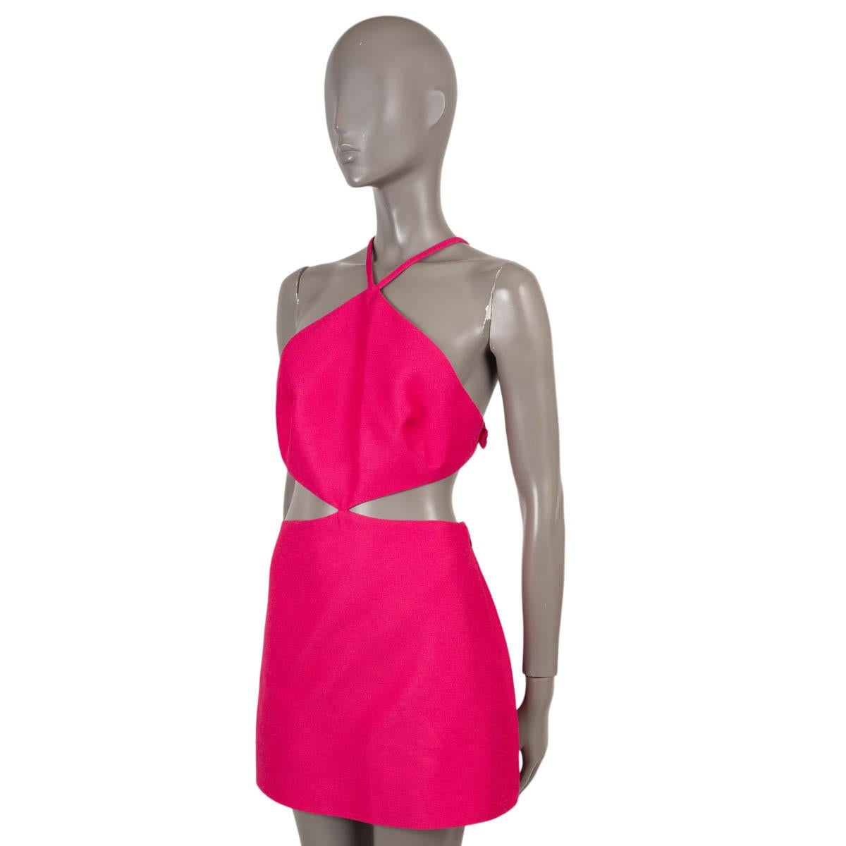 100% authentic Valentino cut-out crêpe mini dress in fuchsia viscose (54%), cotton (36%) and silk (10%). Features four bows on the back and strap. Closes with a zipper and hook on the side lined in viscose (91%) and elasthanne (9%).  Has been worn