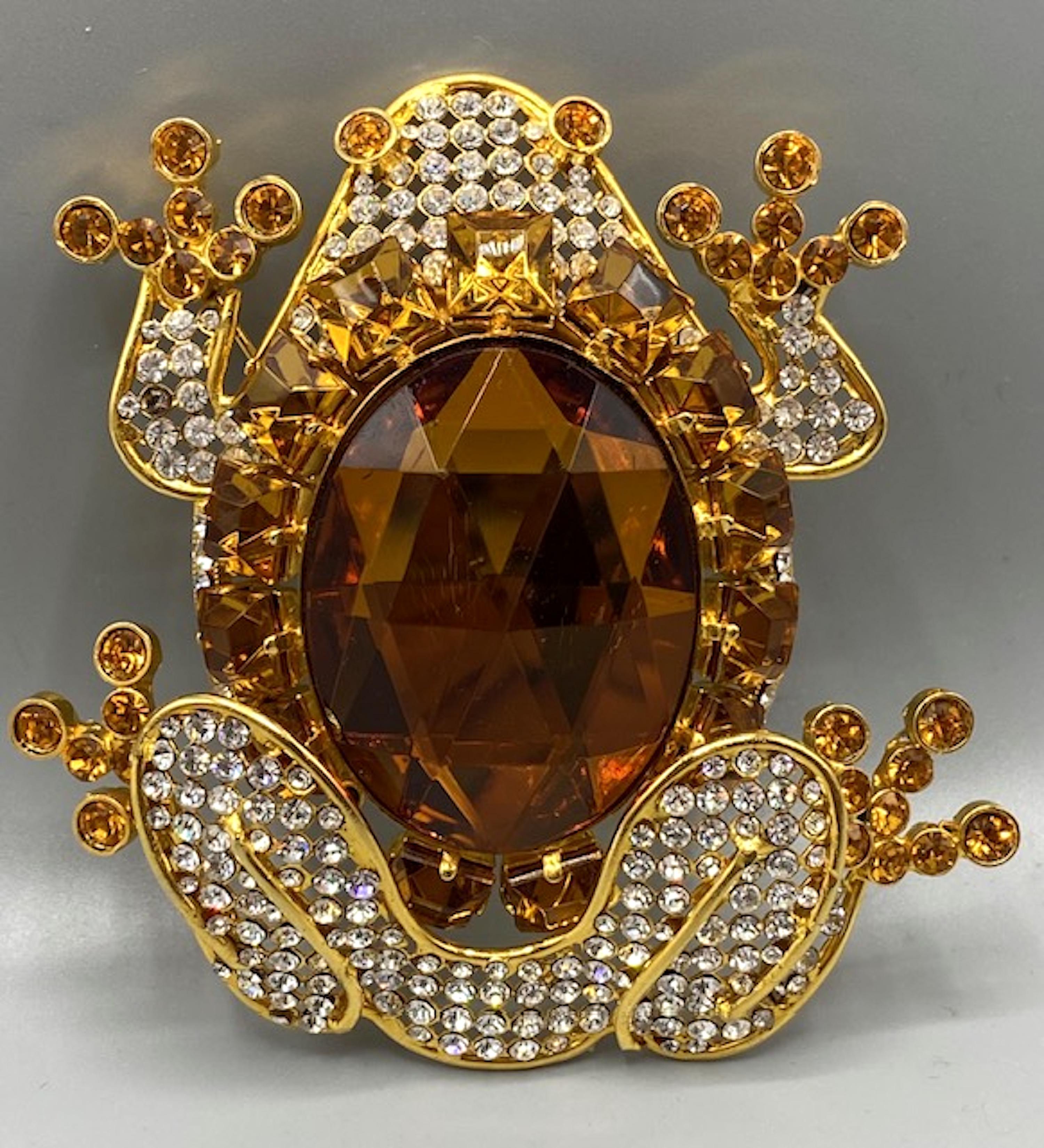 This impressively  large 1980s Valentino Garavani gold-tone frog brooch is particularly glamorous. The piece is encrusted with rhinestones and is centered by a large faceted amber stone that fully embodies the essence of a whimsical crown jewel. 