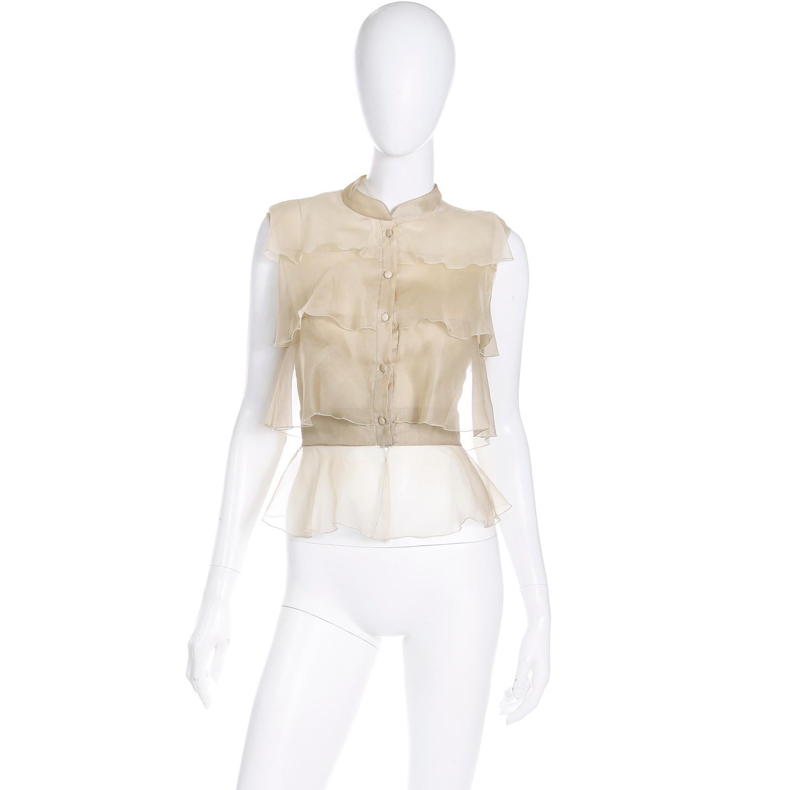 This is a luxurious 2000s sleeveless soft gold Valentino Garavani tiered sleeveless blouse with delicate semi sheer ruffles in an exquisite fine silk chiffon. Tailored to perfection, this top is a timeless piece that will elevate any