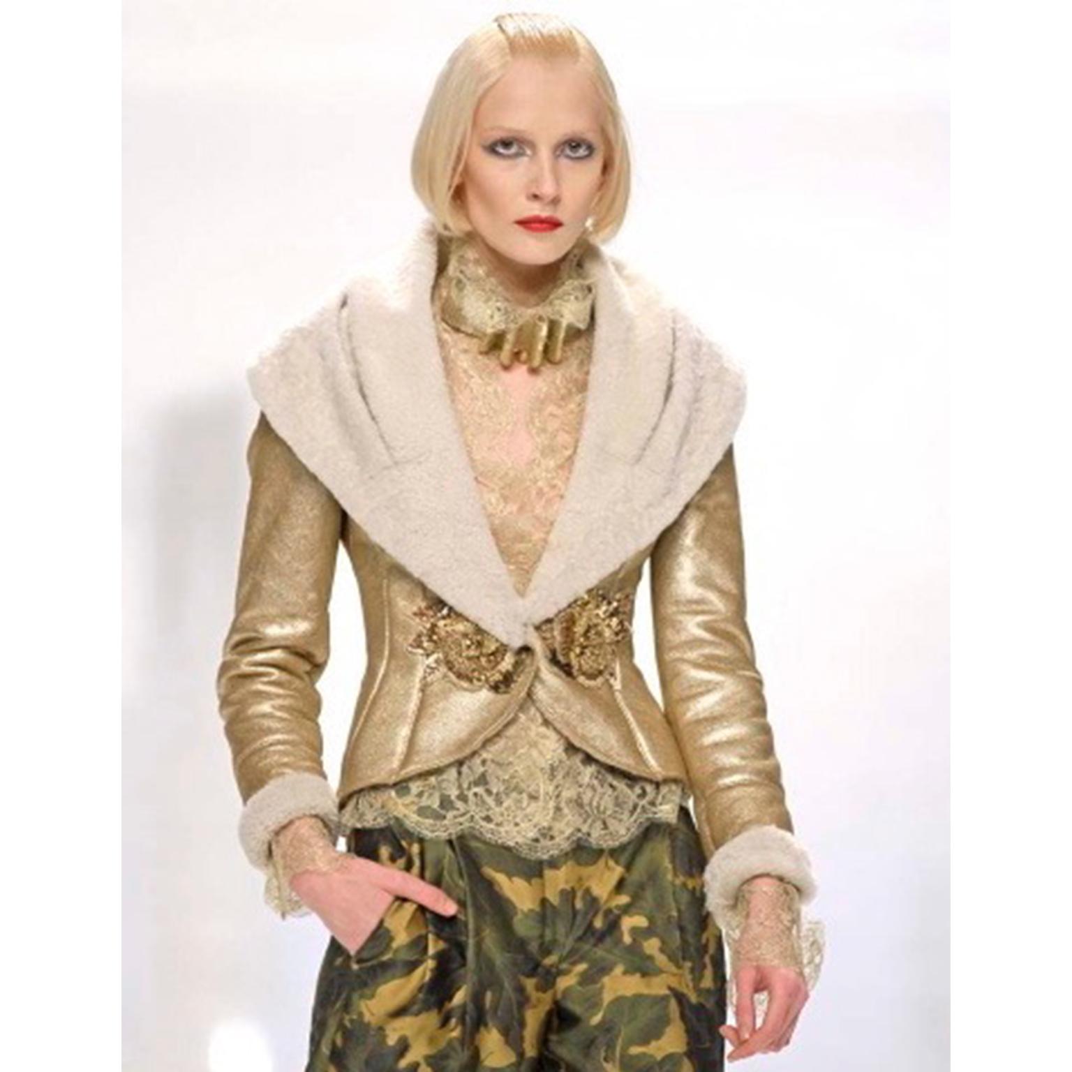 This is a stunning vintage Valentino gold fine lace evening blouse. This incredible top was designed by Valentino Garavani for his Fall Winter 2006 collection. 2006 was the last year that Garavani designed for his label.  The blouse buttons up the