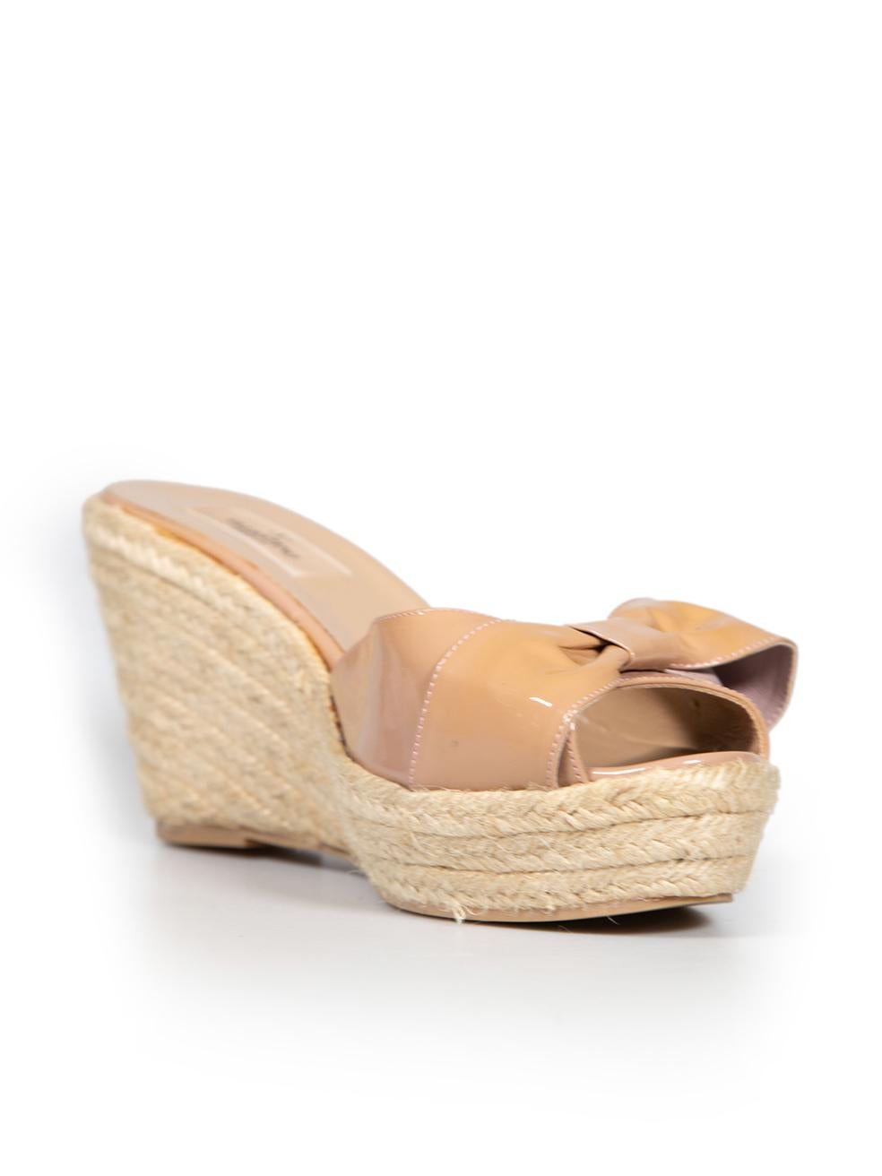 CONDITION is Very good. Minimal wear to sandals is evident. Minimal wear to soles, with some marks to patent leather bows on this used Valentino designer resale item. This item comes with original dust bag.
 
 Details
 Beige
 Patent leather
 Wedge