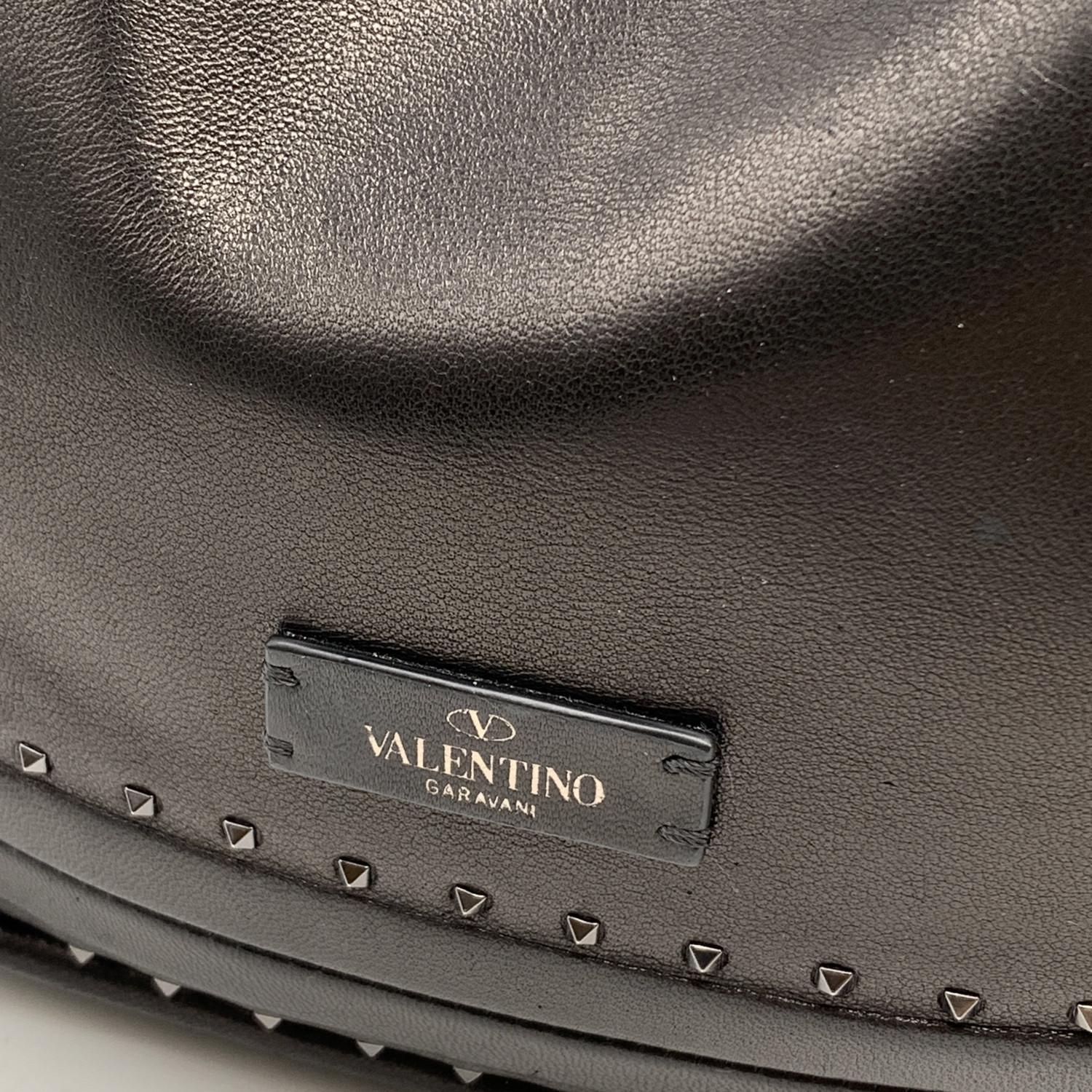 This beautiful Bag will come with a Certificate of Authenticity provided by Entrupy. The certificate will be provided at no further cost.

VALENTINO GARAVANI slouchy tote bag in black leather. Small gunmetal pyramid studs detailing. Magnetic button