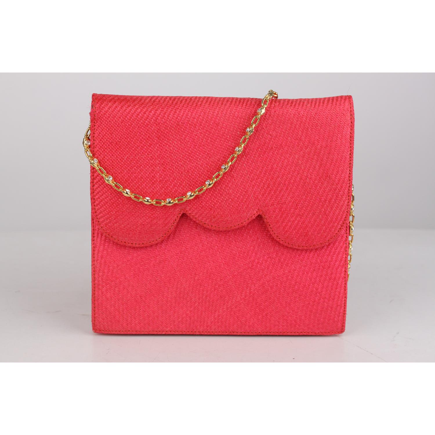 Evening bag signed NIGHT by VALENTINO GARAVANI. Woven raffia in hot pink color. Flap with magnetic button closure. Red leather on the reverse of the flap with embossed V- Valentino logo. Gros-grain fabric lining and 1 side zip pocket inside. Gold