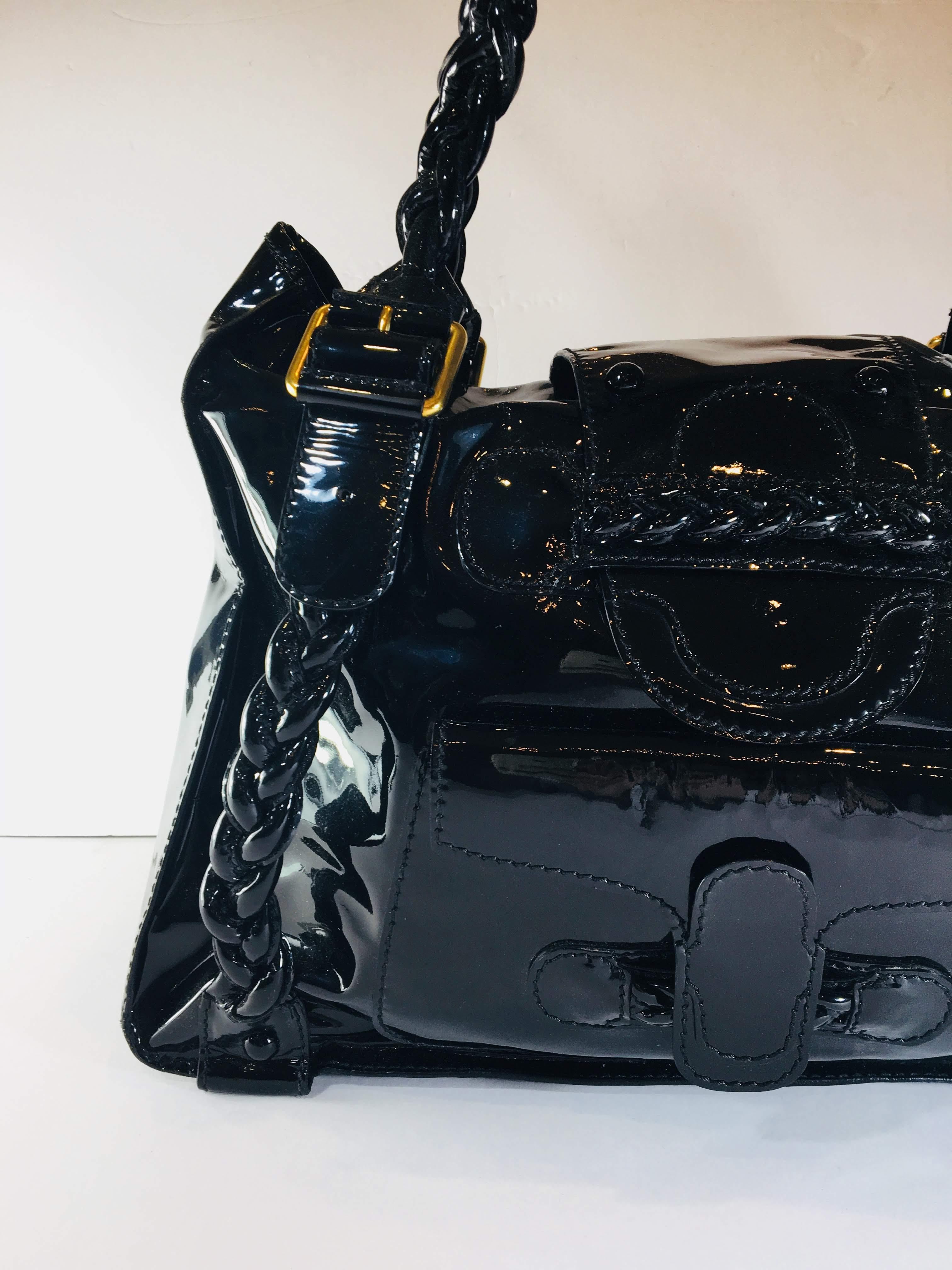 Black Patent Leather Shoulder Bag with Braided Handles and Gold Hardware
15