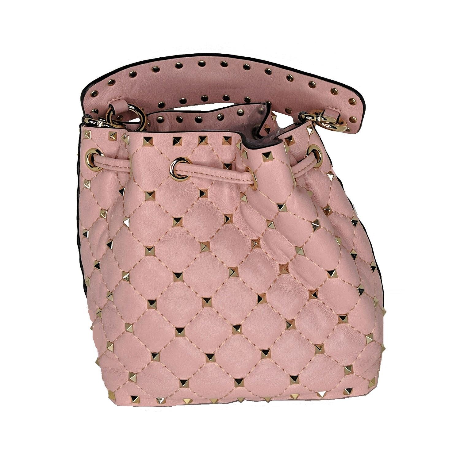Valentino Rockstud Quilted Bucket Bag In Pink. Valentino bucket bag crafted in quilted leather with gold-tone studded hardware and fittings. This bucket bag features 1 main compartment, 2 credit card slots, shoulder strap and drawstring closure.