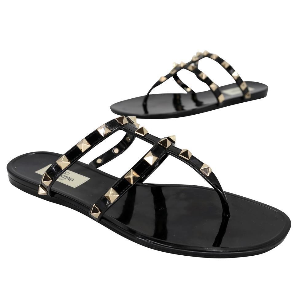 Here is another amazing collection by Valentino, their signature Gladiator rockstud elegant black patent leather sandlas with studded chrome rockstud on PVC sandals vet fashion forward with elegant modern strap and glossy finish here is your chance