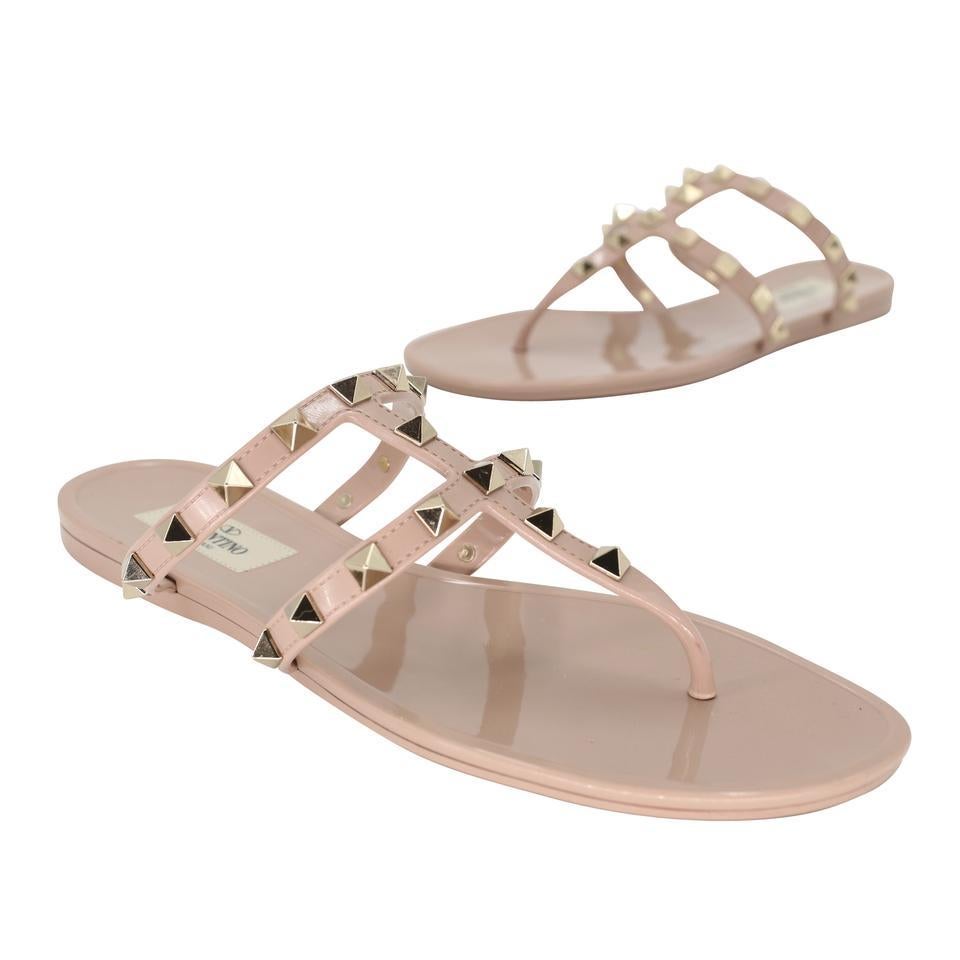 Here is another amazing collection by Valentino, their signature Gladiator rockstud elegant nude beige patent leather sandlas with studded rockstud on PVC sandals vet fashion forward with elegant modern strap and glossy finish here is your chance to