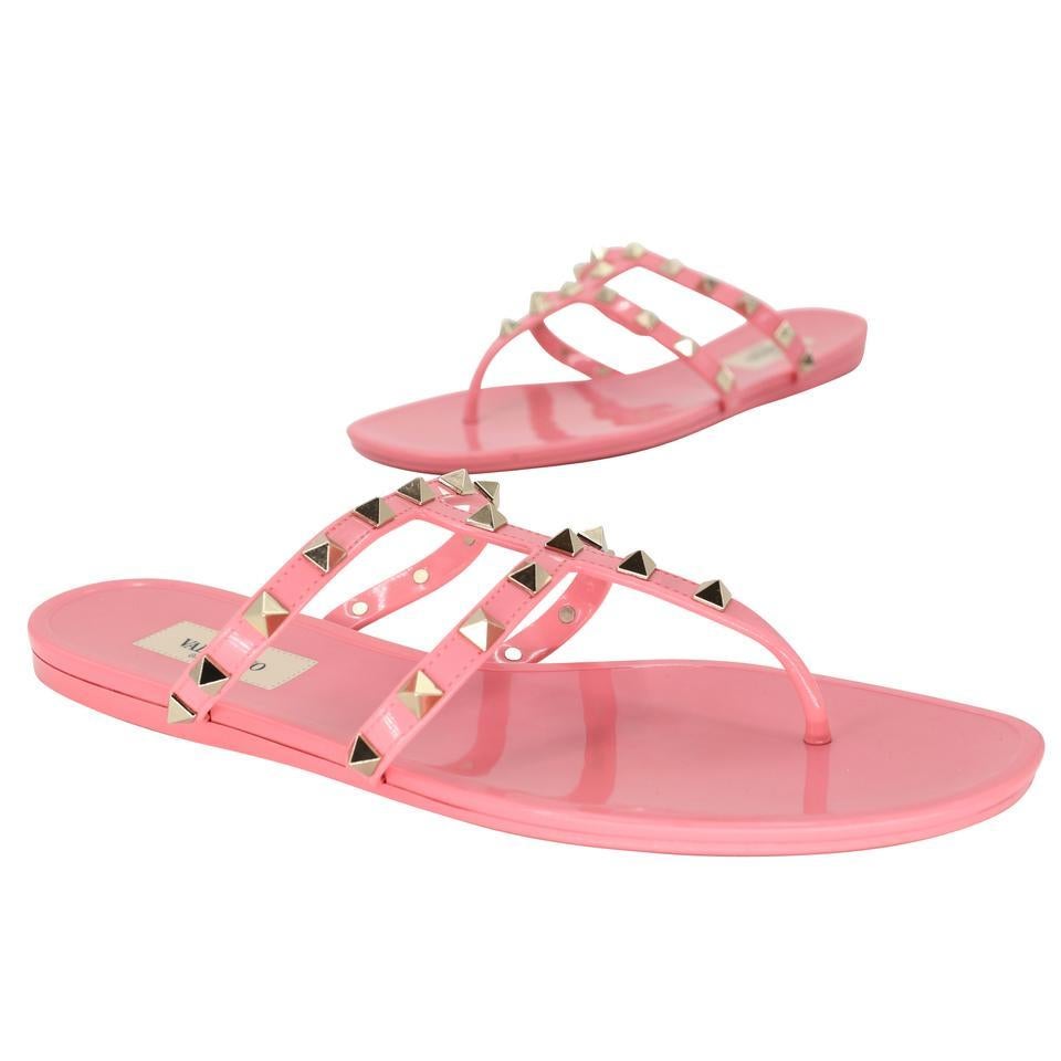 Here is another amazing collection by Valentino, their signature Gladiator rockstud elegant pink patent leather sandals with studded rockstud on PVC sandals very fashion-forward with elegant modern strap and glossy finish here is your chance to