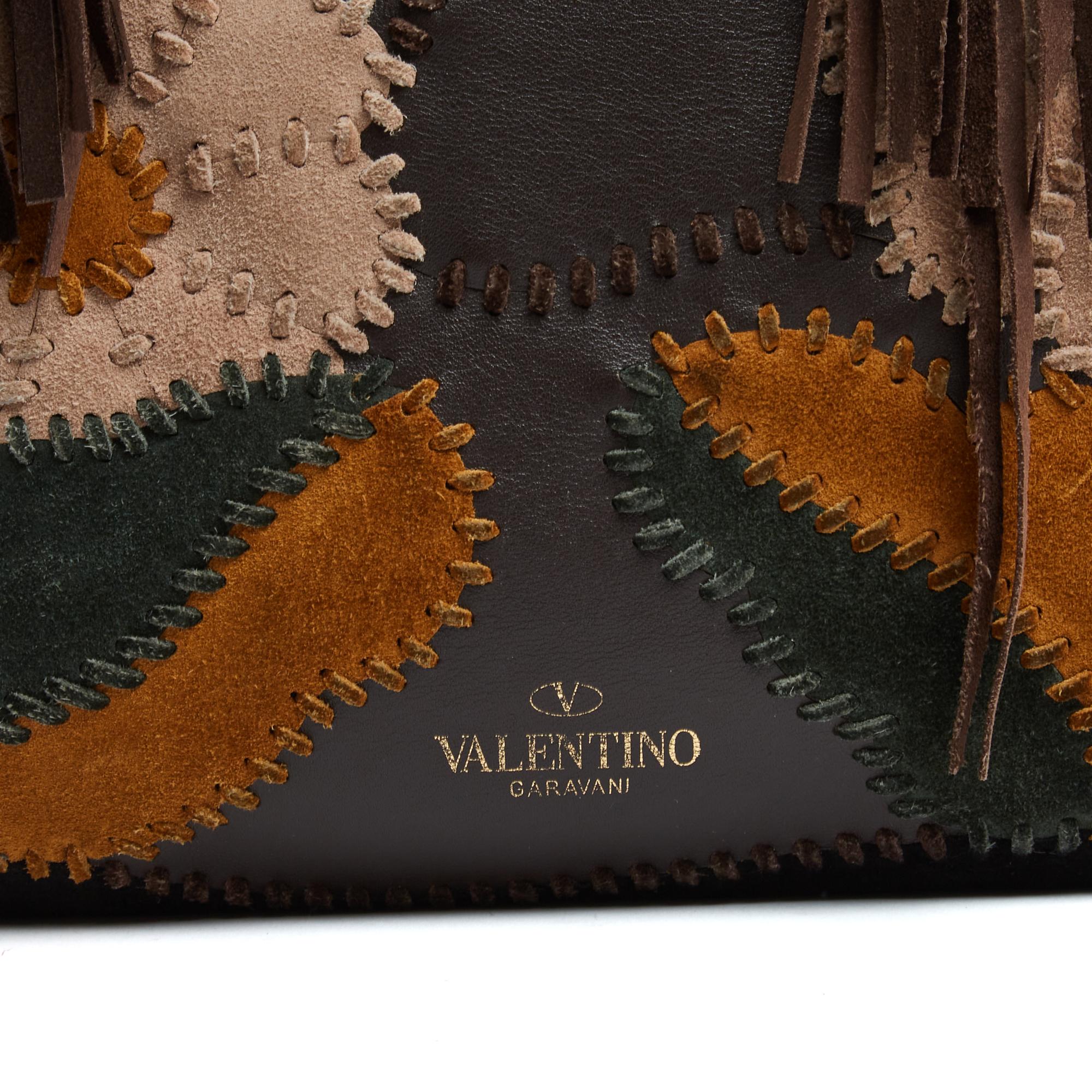Valentino Garavani C-Rockee tote bag in brown suede embroidered with a multi-colored suede floral pattern, brown suede fringes on the sides, camel or gold suede interior with 2 large pockets closed by a zip. Width 36 cm x height 28 cm x depth 18 cm,
