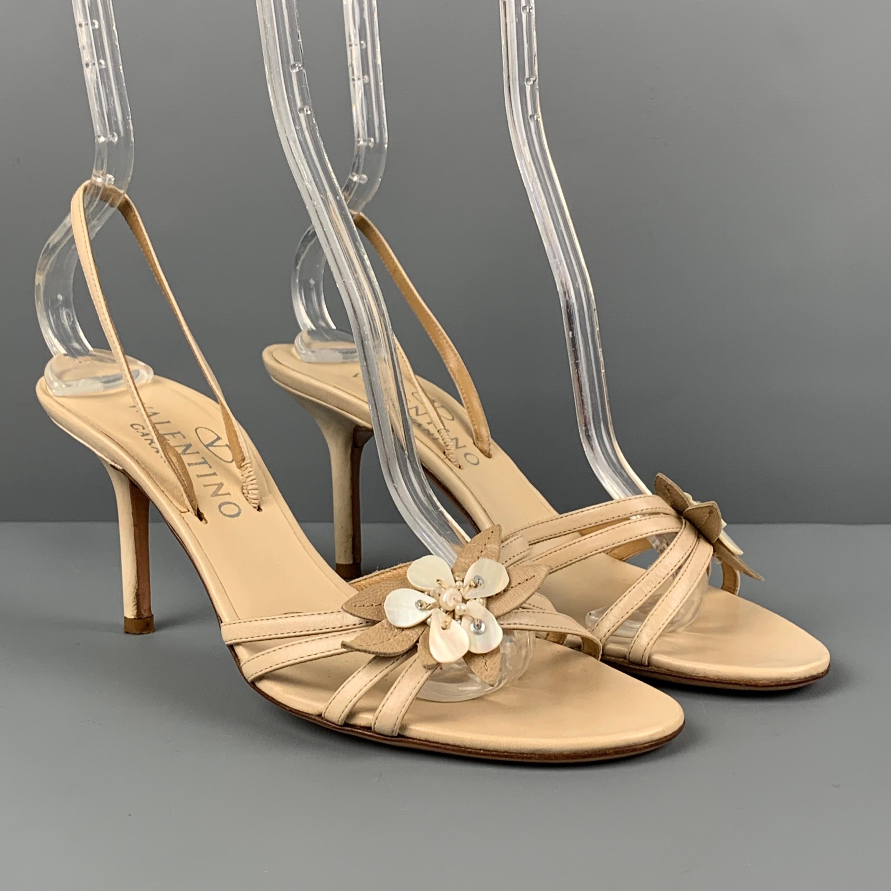 VALENTINO GARAVANI sandals comes in a beige leather featuring a slingback style, open toe, flower applique detail, and a stiletto heel. Made in Italy.

Very Good Pre-Owned Condition.
Marked: 37

Measurements:

Heel: 3 in. 
