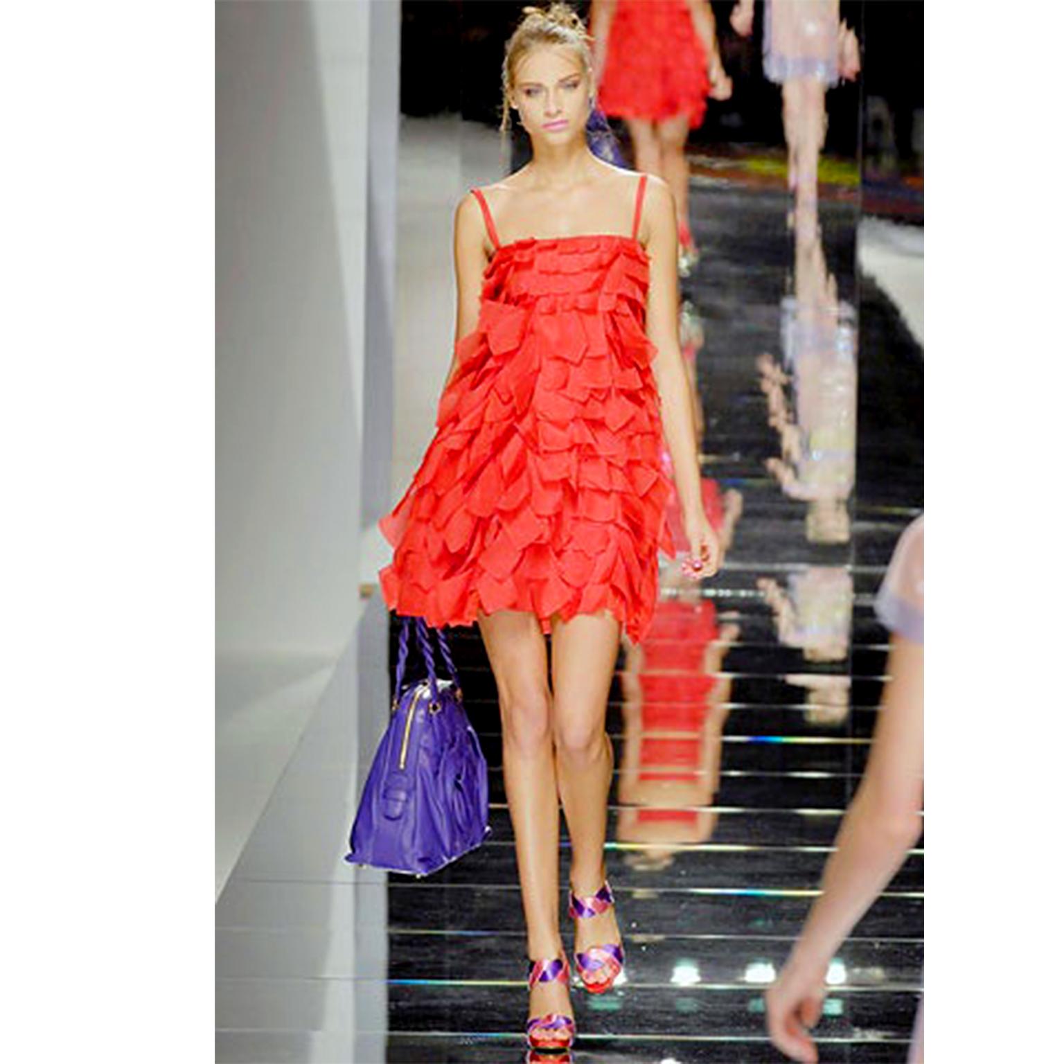 This show stopping Valentino red silk Organza dress is from Valentino Garavani's Spring/Summer 2008 final runway show. We love the way the flat loops of silk organza take on the look of wide fringe. In true Valentino fashion, the loops are sewn in