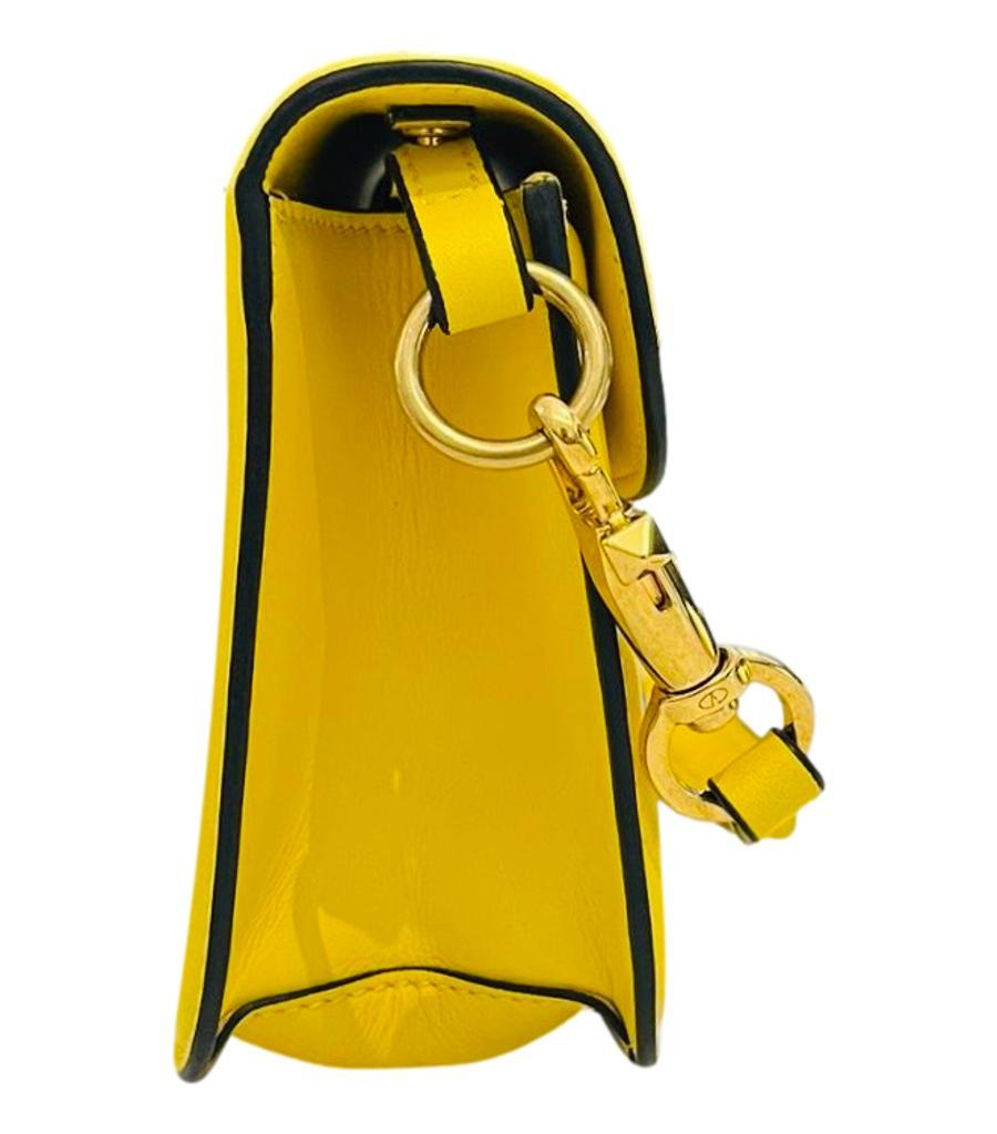 Valentino Garavani 'V' Logo Loco Shoulder Bag

Bright yellow shoulder bag crafted in calfskin and designed with signature 'V' logo detail to the front.

Featuring detachable top handle and gold chain strap.

Magnetic closure leading to tonal leather