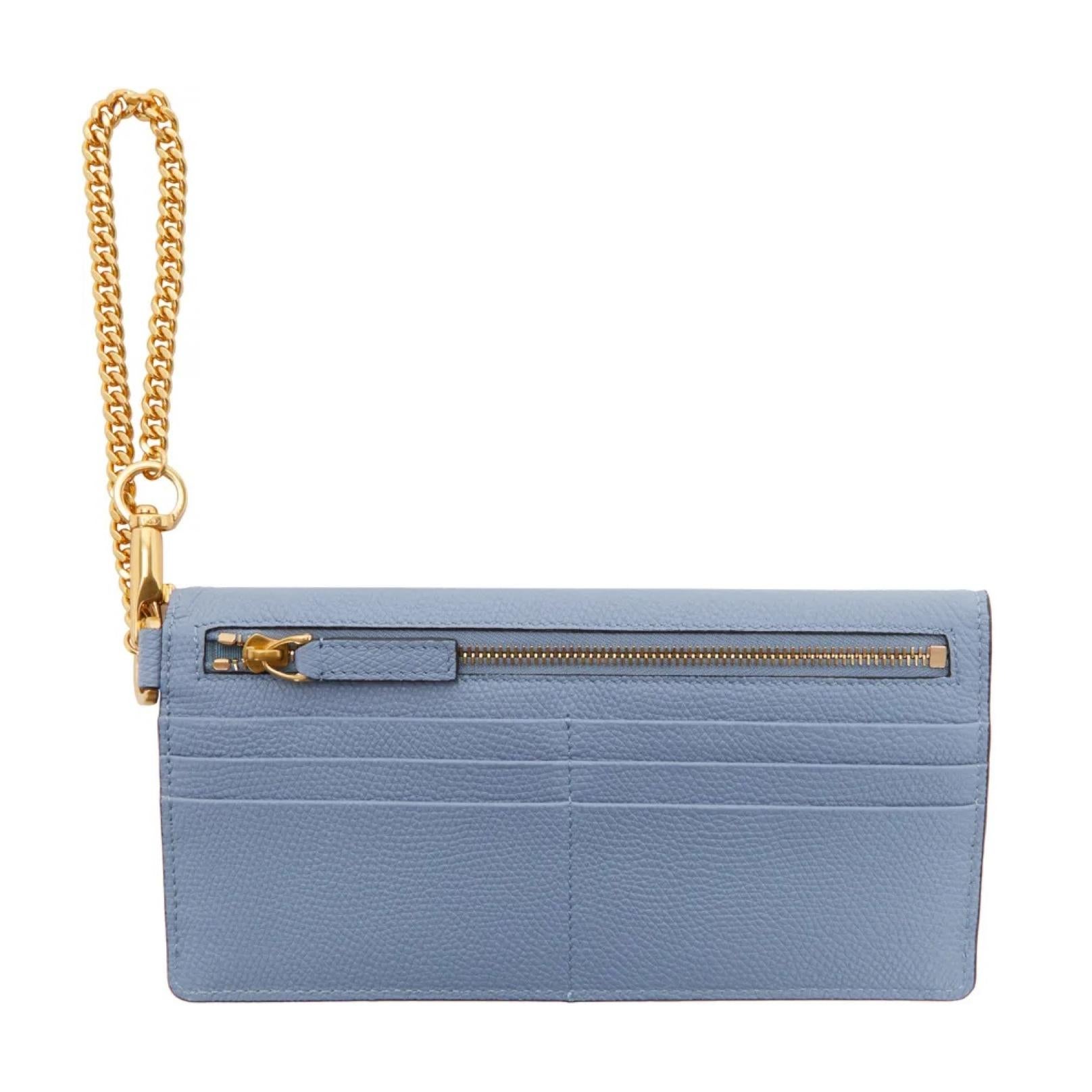 This pouch clutch is made with grained calfskin in baby blue. The bag features gold-tone hardware, a curb chain strap with lanyard clasp fastening at side, Logo hardware at face, exterior zip pocket and card slots at back, press-stud closure at main