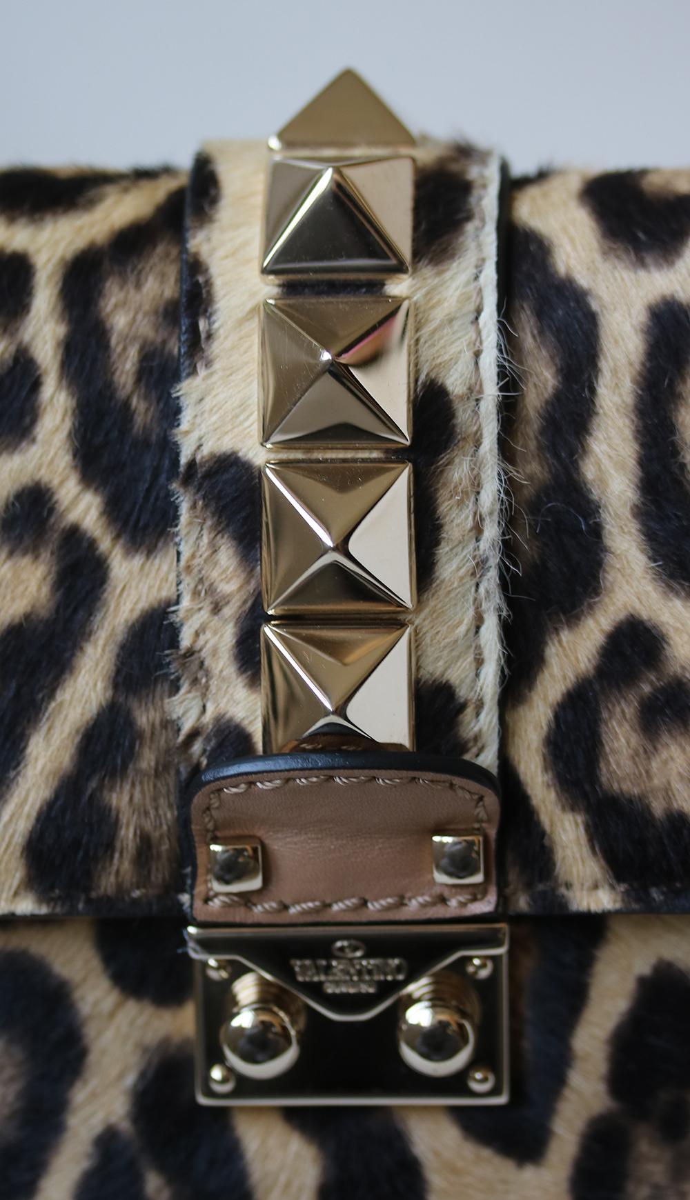 Hand-applied pyramid studs give Valentino Garavani's 'Lock' bag its inimitable finish. This calf-hair leopard-print design has been crafted in Italy with a compact canvas-lined interior that will easily house your smartphone, makeup compact and