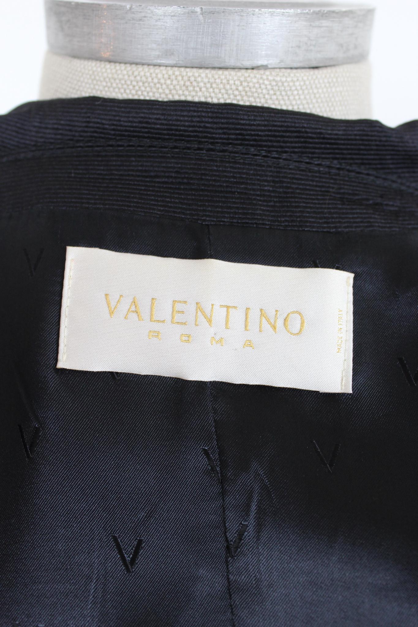 This shiny black Valentino jacket is elegant and refined. The slim fit design and elasticated waistband offer a flattering and comfortable fit, making it perfect for any evening event. The glossy black color is timeless. This jacket is from the