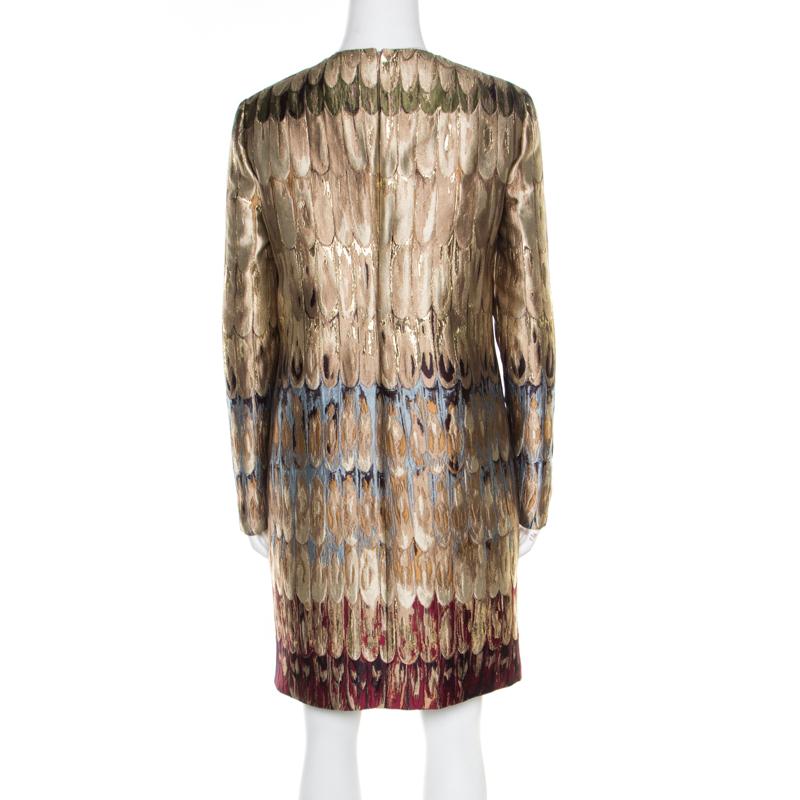 Inspired by the beauty of birds, this Valentino dress is covered in jacquard feathers and hints of contrast colours with the gold. The dress has long sleeves, a round neckline and a back zipper. Because it is such a standout piece, the dress can be
