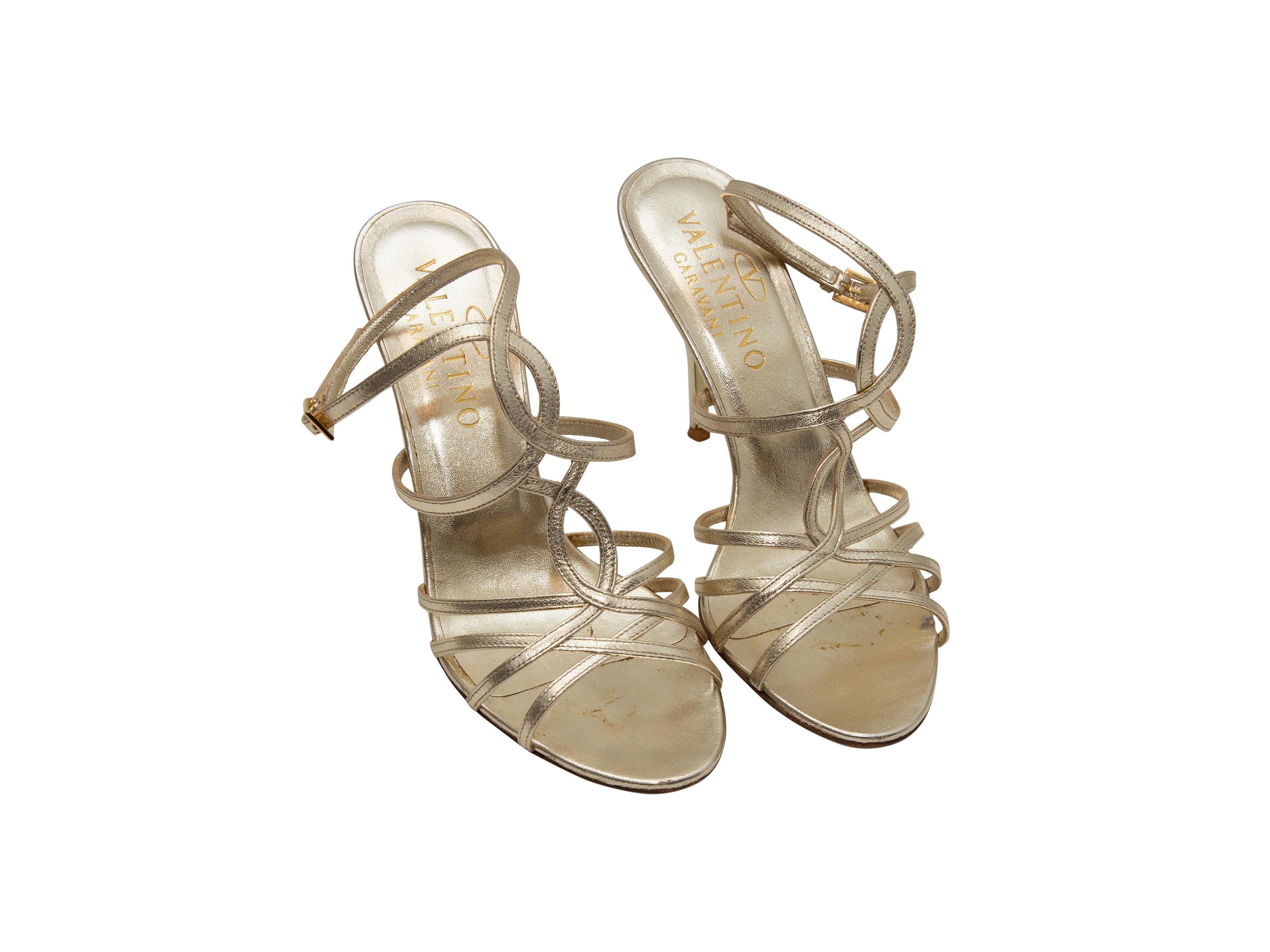 Product details: Gold metallic leather strappy heeled sandals by Valentino. Gold-tone buckle closures at ankle straps. Designer size 36.5. 4
