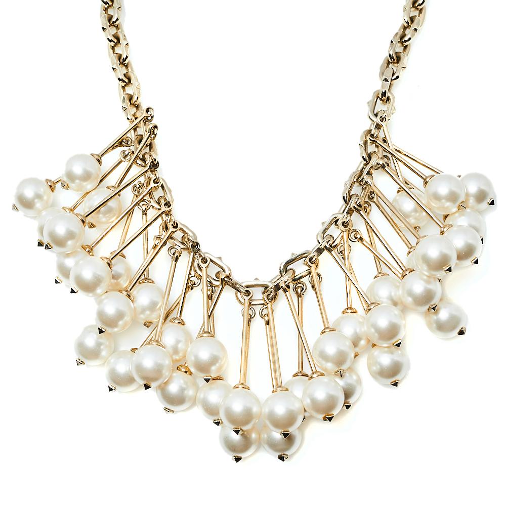 Let this Valentino necklace be your new favorite accessory. Made from gold-tone metal, the chain holds a gathering of hanging faux pearls. You can wear it solo or layer it with other necklaces for a stylish layering effect.

Includes: Original Tag,