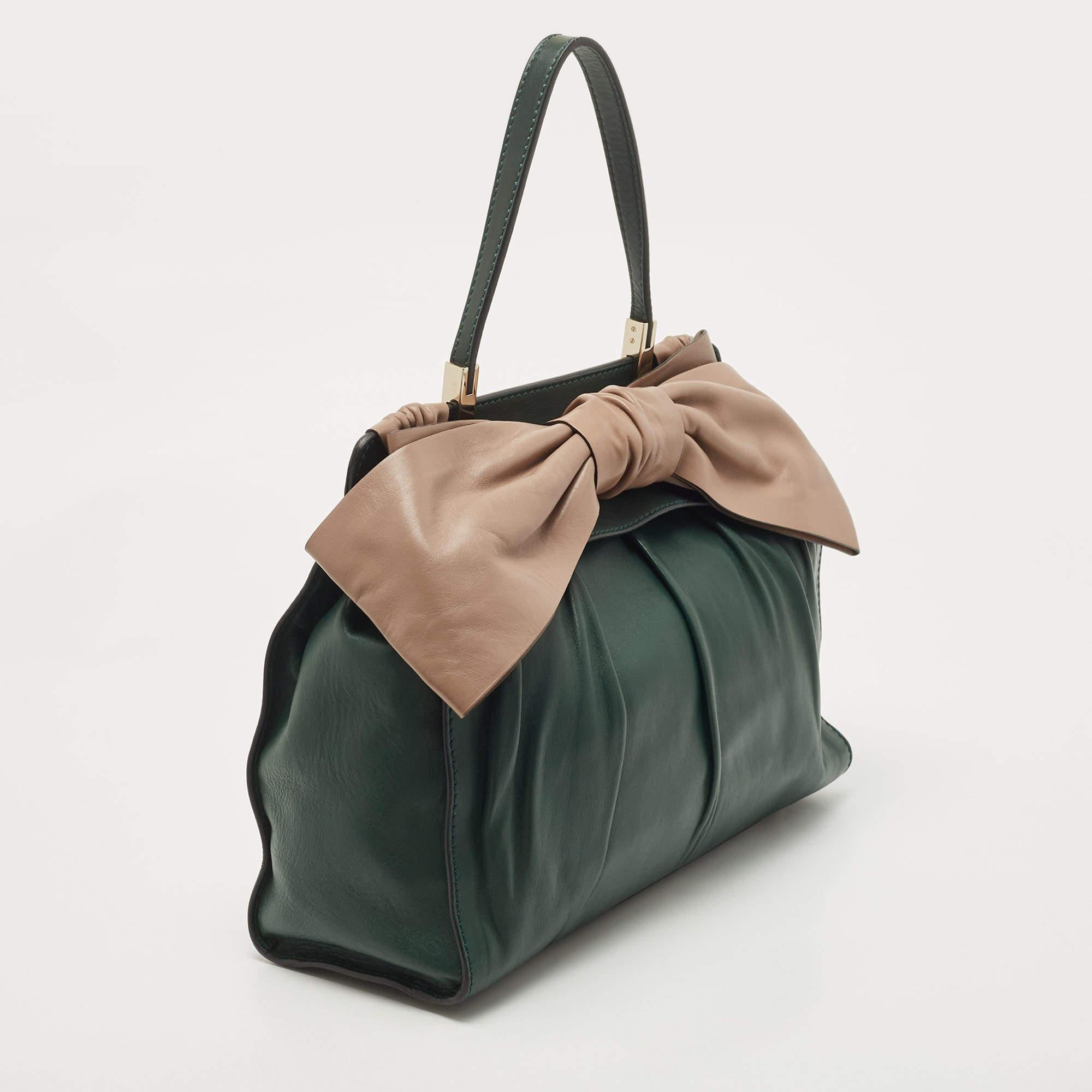 Imparting unparalleled elegance and sophistication, this designer bag is made from quality leather in a gorgeous hue. While the interior offers ample space, the top handle allows you to carry it with much style.
included
Original Dustbag, Info
