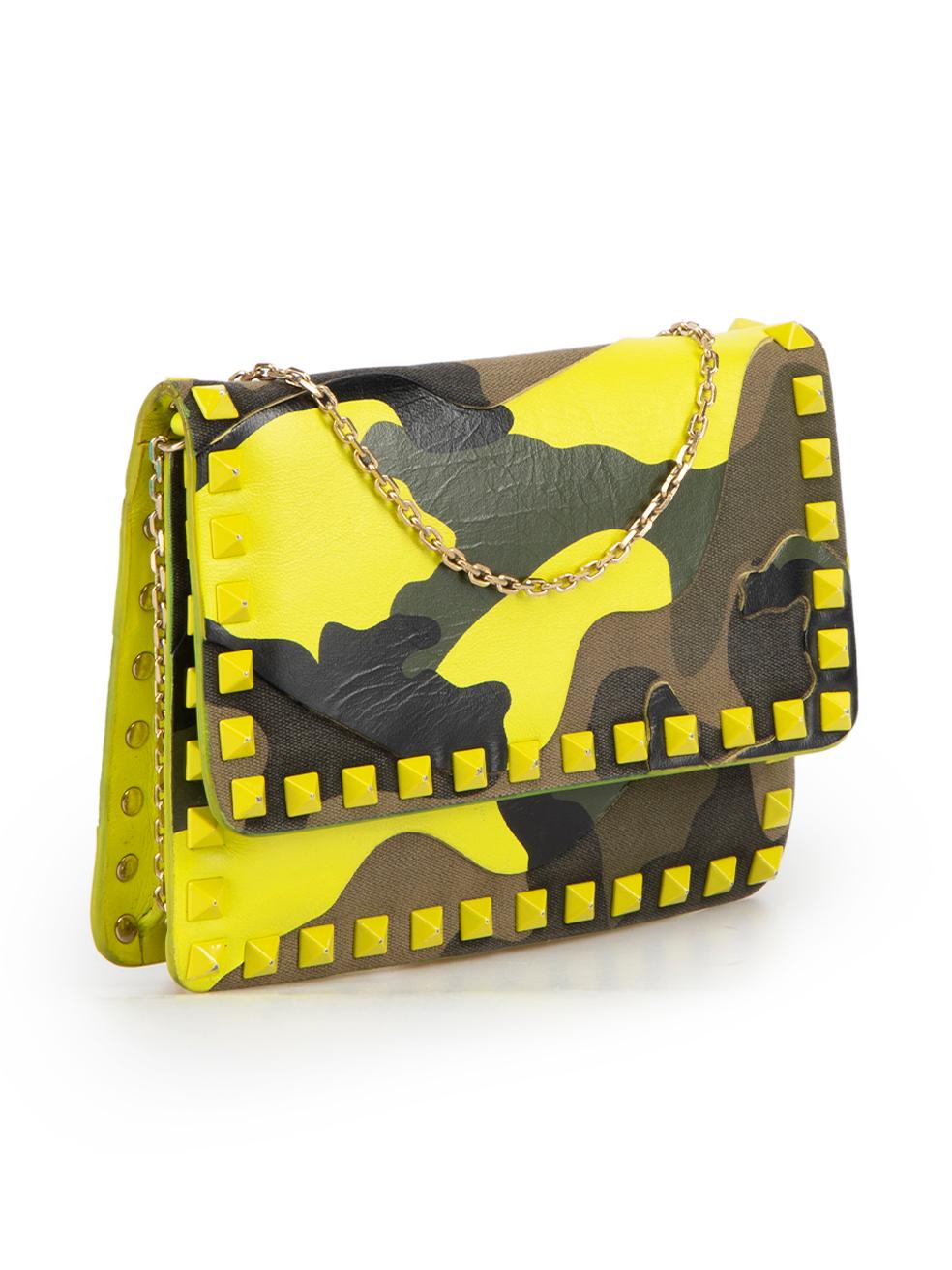 CONDITION is Good. Minor wear to pouch is evident. Light wear to the leather camouflage panelling with marks and general creasing of the leather throughout. The rockstud embellishment also has chips to the neon paint on this used Valentino designer