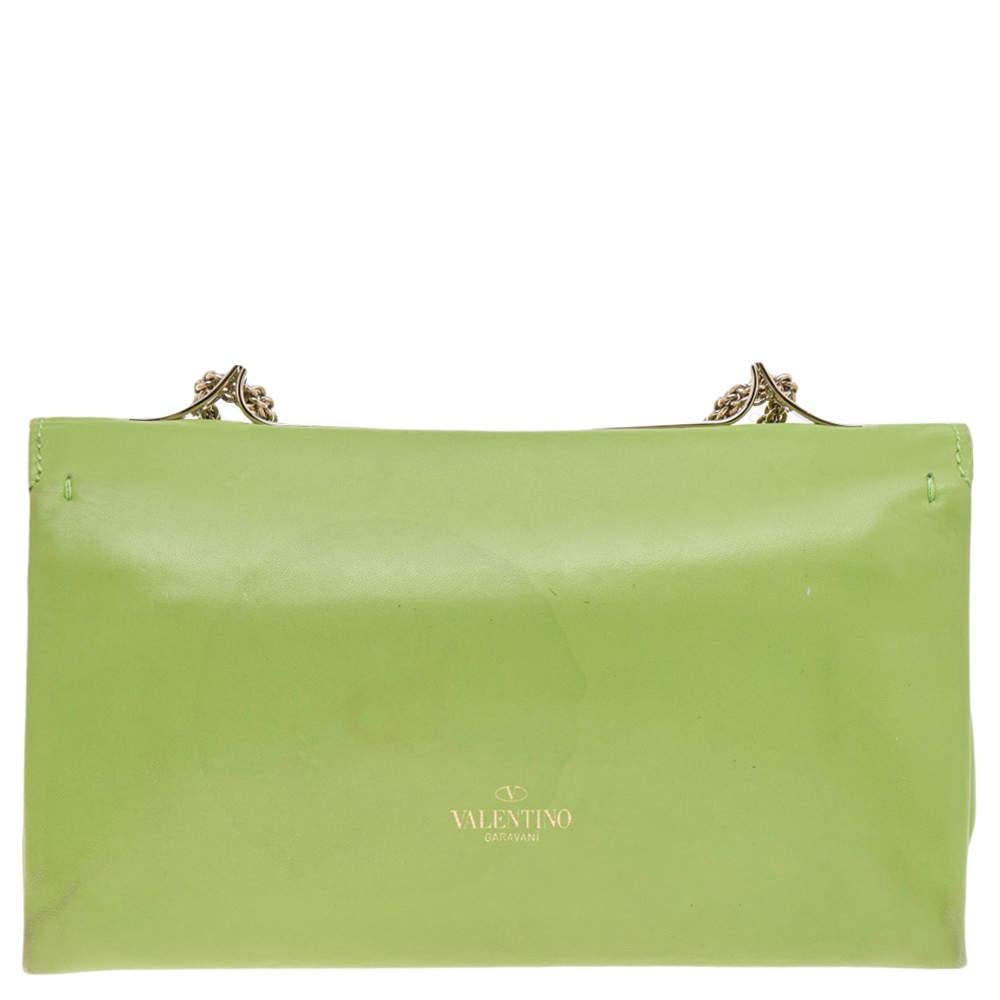 This Va Va Voom clutch from Valentino has an appealing design. Crafted from quality leather in a green shade, the creation features a gorgeous flap, a well-sized interior, and a shoulder chain. It also comes with a hand slot that is decorated with