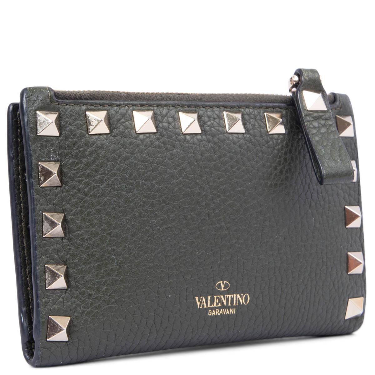 100% authentic Valentino zipper coin purse in forest green grained calfskin embellished signature Rockstud border. Bi-fold construction with a push-button closure. Interior is lined i calfskin and has eight credit card slots and two small bill