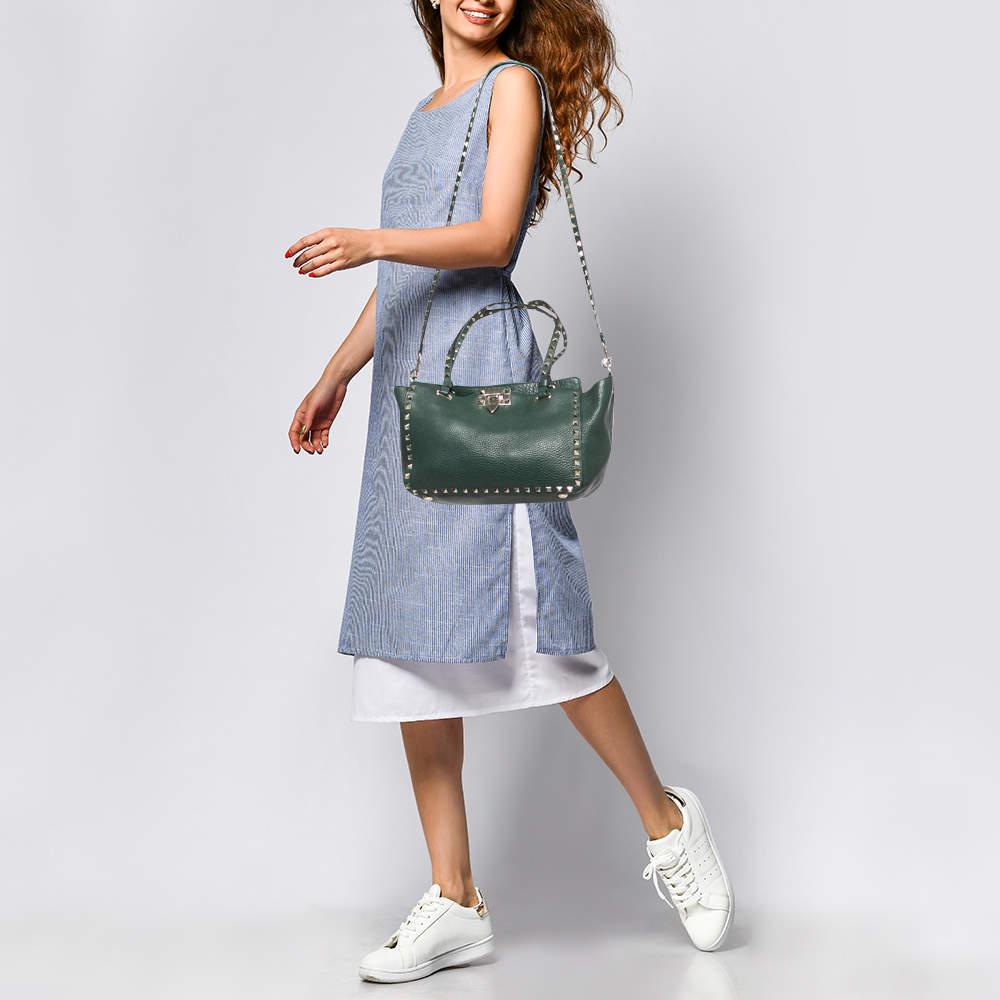 Luxury Italian fashion house Valentino is famed for its classic designs infused with its own signature modern edge and Rockstud details, as showcased by this Trapeze tote. Crafted from leather, it features a detachable shoulder strap accented with
