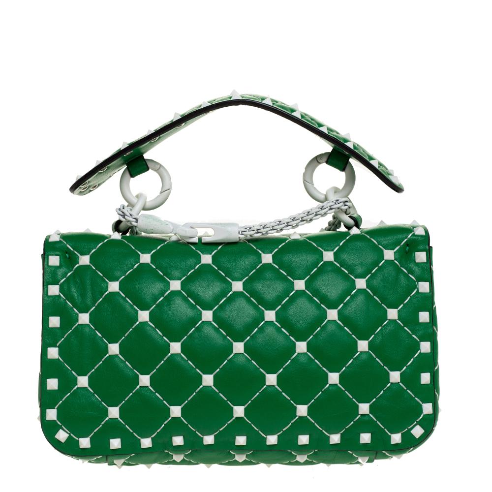 Let Valentino Garavani’s feminine sensibilities take center-stage with the iconic Spike bag – notice how the Rockstuds glow and sparkle against the green quilted leather. Crafted in Italy, it is perfectly shaped to easily stow your everyday