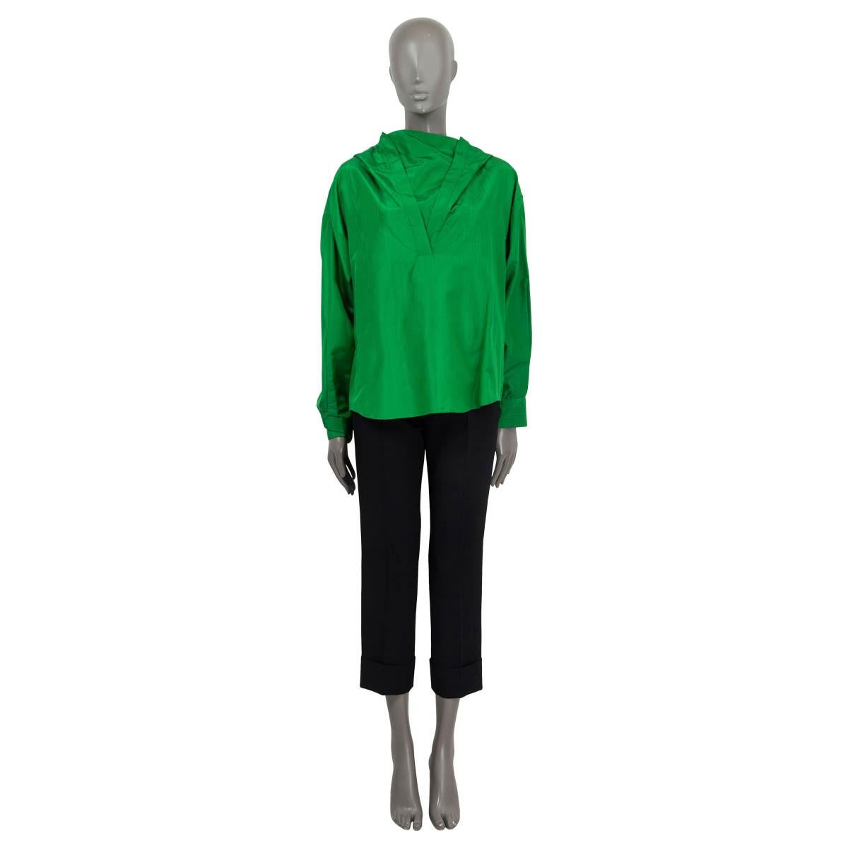 100% authentic Valentino Spring/Summer 2022 oversized hooded anorak blouse in green silk (100%). Features long sleeves and buttoned cuffs. Unlined. Has been worn once or twice and is in virtually new condition.

Measurements
Tag