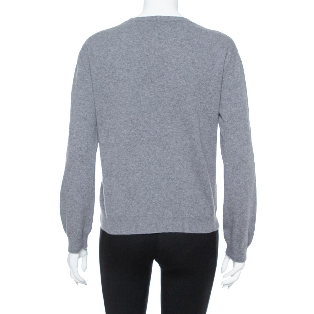 Valentino adds a distinctive twist to a classic grey sweater with this effortlessly cool piece. It's crafted from a soft cashmere blend, features a crew neck and ribbed edges, and is finished with a vibrant intarsia-knit logo in pink and black.

