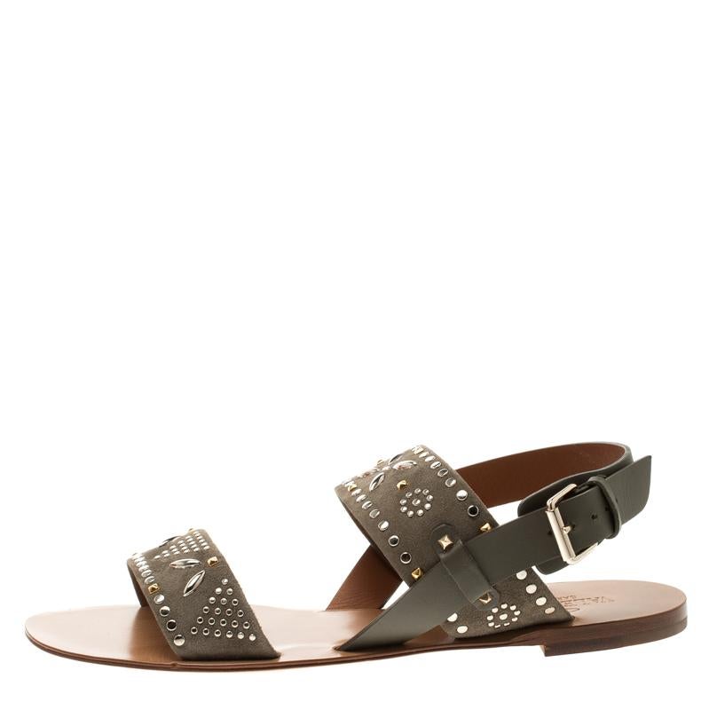 How trendy are these flat sandals from the house of Valentino! They've been crafted from suede and designed with straps that carry gorgeous embellishments. You can wear them with your casual outfits or with dresses.

Includes: Original Box, Info