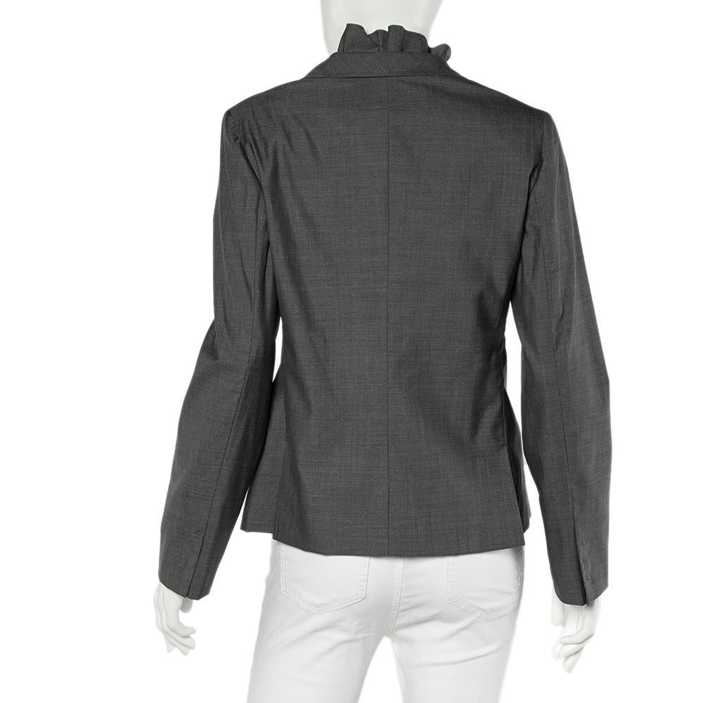 Look uber chic by choosing this Valentino blazer. This grey creation will perfectly elevate your chic casual looks. It is complete with beautiful lapels, ruffle detailing, long sleeves, and an open front secured with a button fastening at the