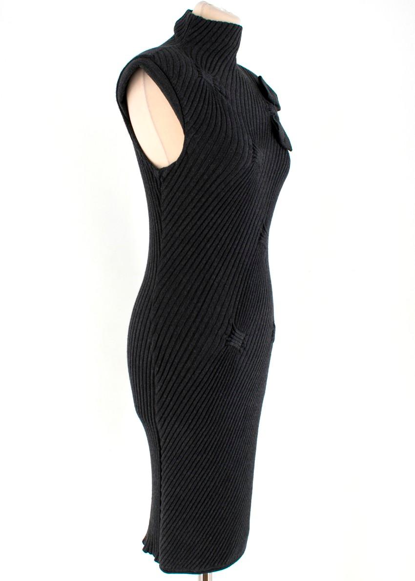 Valentino ribbed mini dress featuring a sleeveless design, turtle neck, shoulder pads and a bow to the front. 

- Slip-on
- Ribbed design
- Slim fit



Composition:
- 70% wool
- 20% silk
- 10% cashmere
- Made in Italy

Please note, these items are